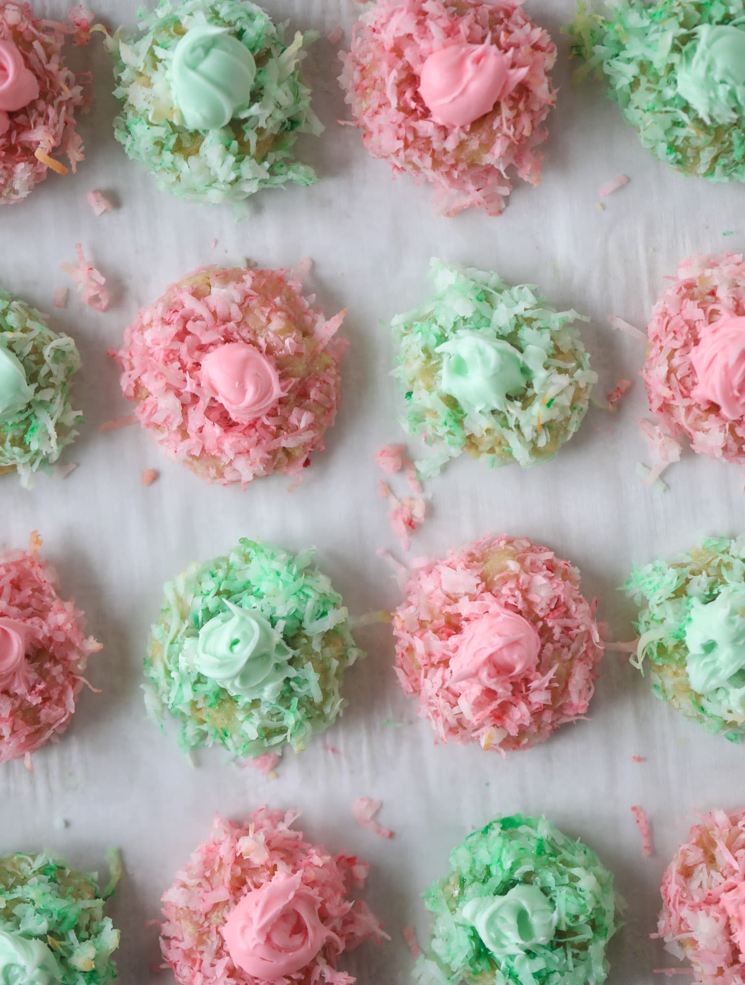 These thumbprint cookies are so perfect for the holiday season. The best butter thumbprint rolled in pink and green coconut and filled with buttercream. So festive! I personally think they look like Grinch cookies - kids love them! I howsweeteats.com #thumbprint #cookies