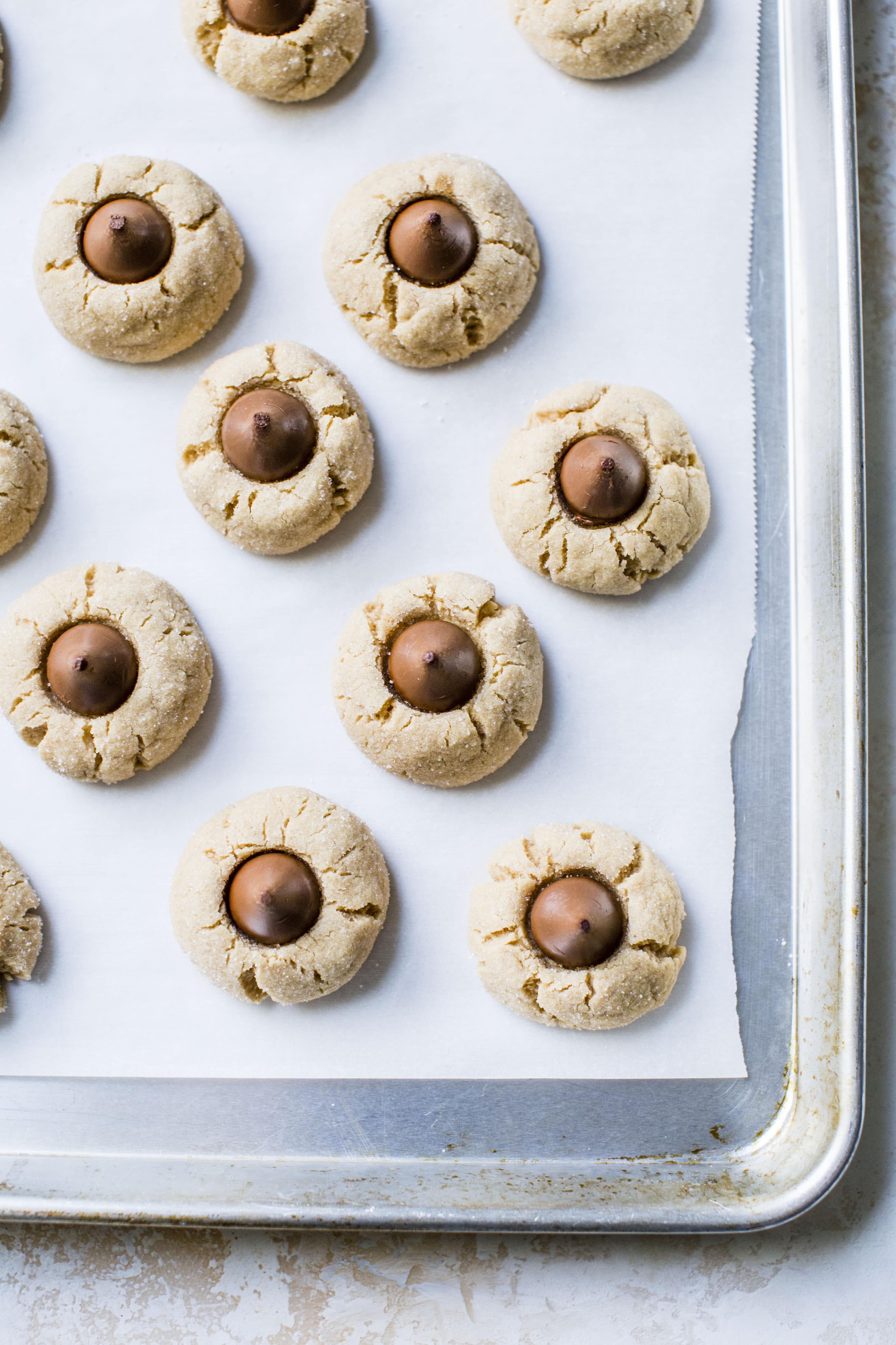 These are perfect peanut butter blossoms! My favorite cookie at christmastime has always been classic peanut butter blossoms and my grandma had the recipe nailed. These are super easy, delicious and will make a lot of cookies! I howsweeteats.com #peanutbutter #blossoms