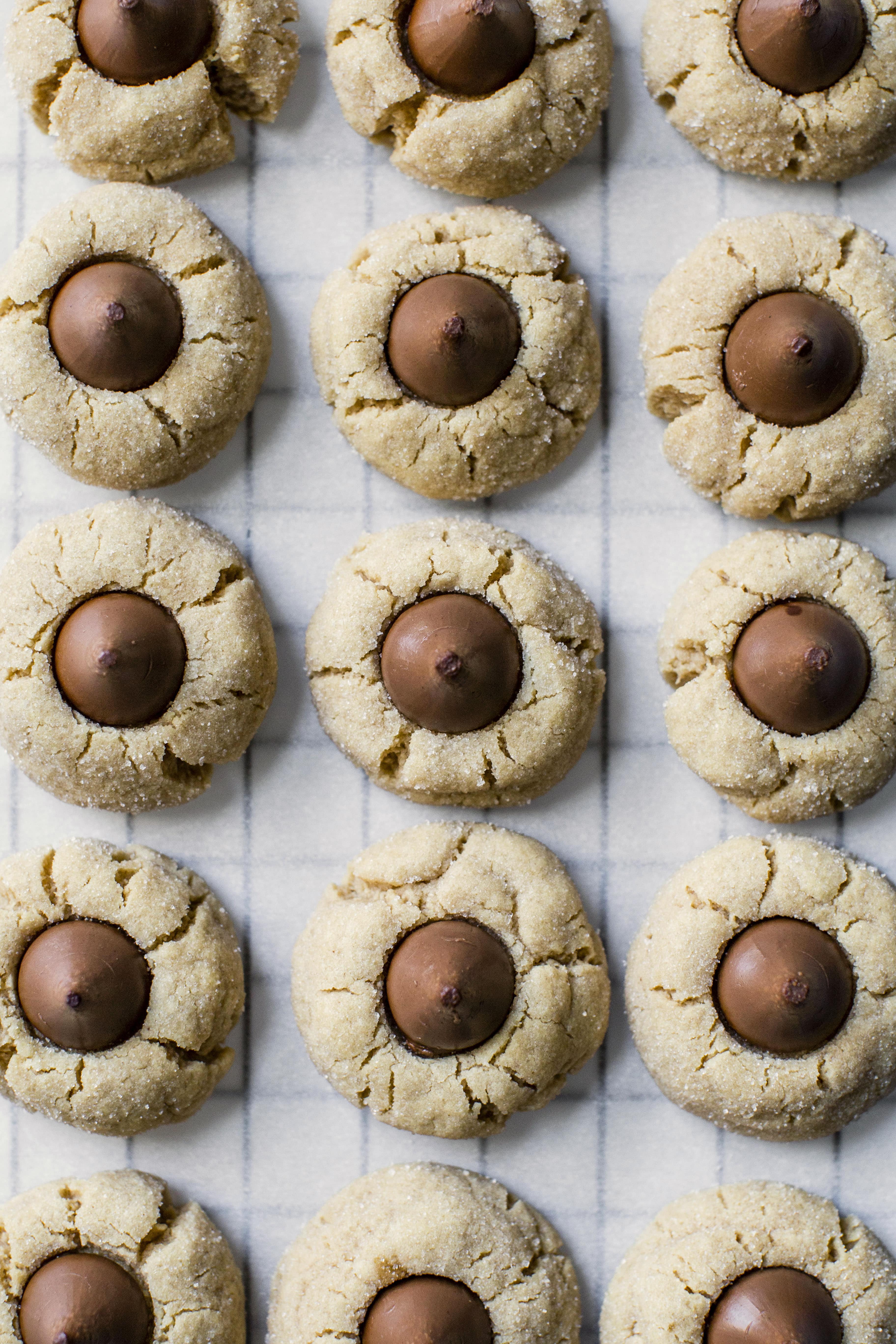 These are perfect peanut butter blossoms! My favorite cookie at christmastime has always been classic peanut butter blossoms and my grandma had the recipe nailed. These are super easy, delicious and will make a lot of cookies! I howsweeteats.com #peanutbutter #blossoms