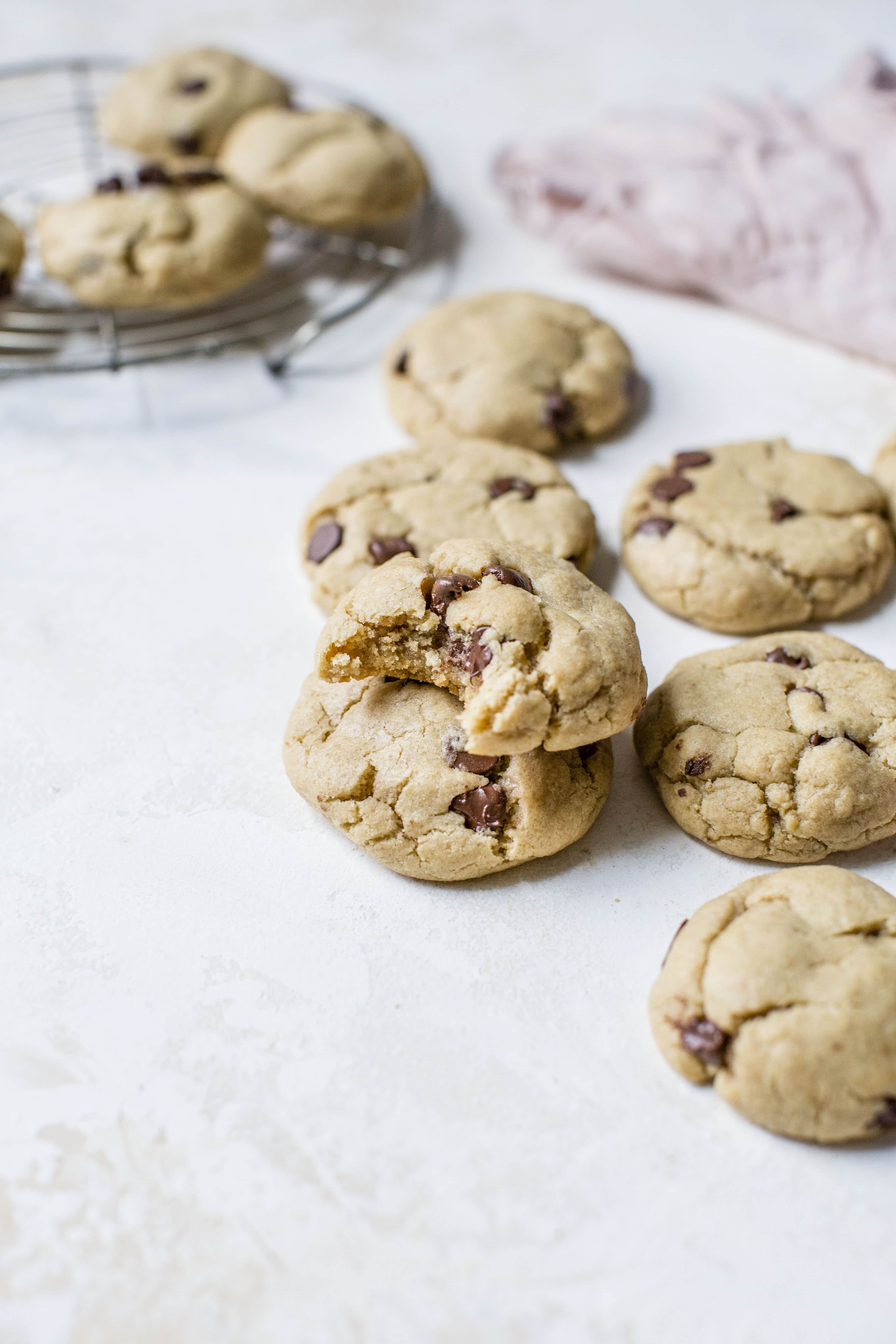 These puffy peanut butter cookies with chocolate chips are my most favorite peanut butter chocolate chip cookie ever! They are soft but also a little chewy and the combination is just to die for! Comes together super easily too. I howsweeteats.com #peanutbutter #cookies