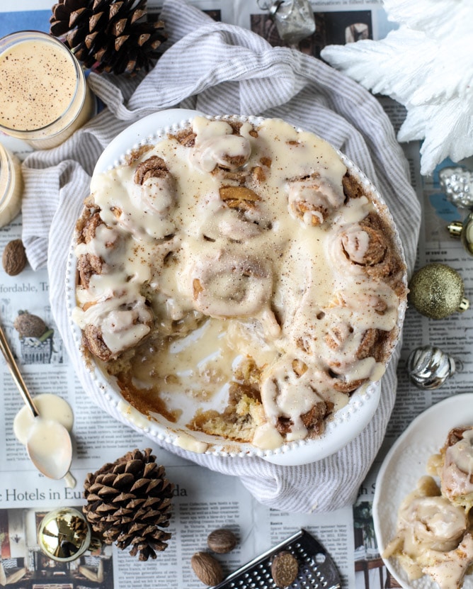 These super easy one hour cinnamon rolls are infused with eggnog and drenched in an eggnog icing with a sprinkle of fresh nutmeg. I howsweeteats.com #onehour #cinnamonrolls #eggnog