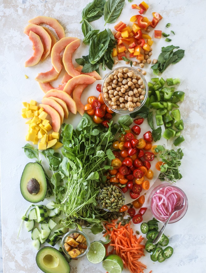 This spicy rainbow salad is chock full of gorgeous, fresh produces, chickpeas, plantains and herbs for one beautiful sight in a bowl. The rainbow salad is satisfying, filling, delicious with a touch of sweet and slightly spicy - everything you want in a meal! I howsweeteats.com #spicy #rainbow #salad 