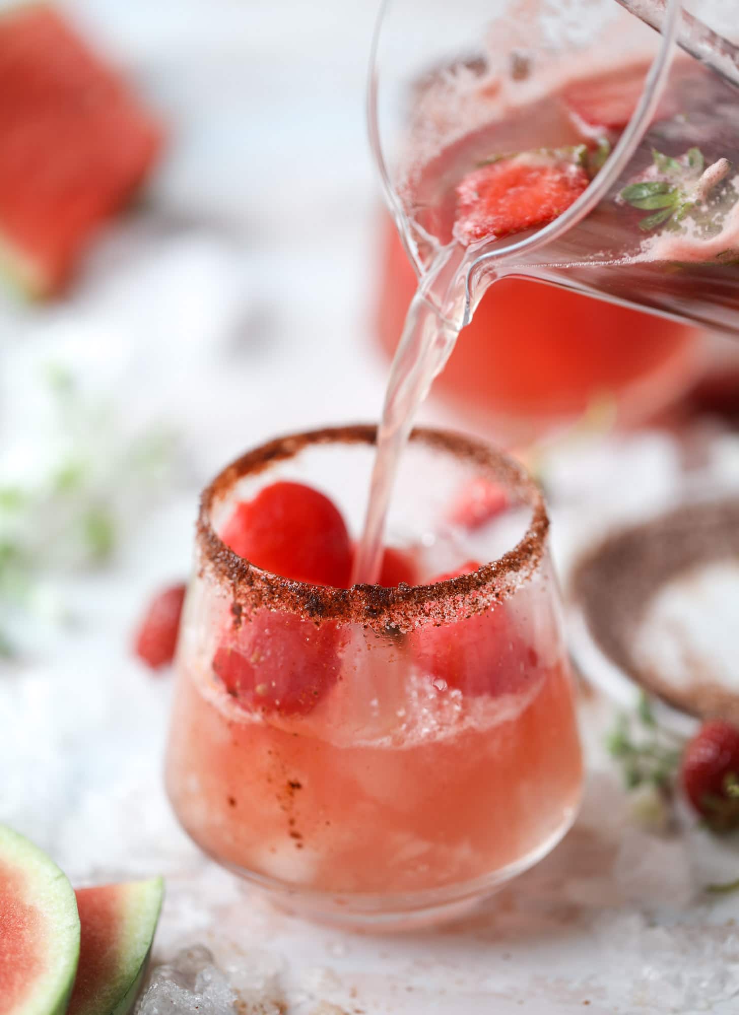This spicy watermelon sangria is super refreshing, light, delicious and perfect for a hot summer day! Complete with an entire bottle of rosé, watermelon juice, melon balls, strawberries and brandy, this is the best summer cocktail in a pitcher! I howsweeteats.com #spicy #watermelon #sangria #cocktails #rosé