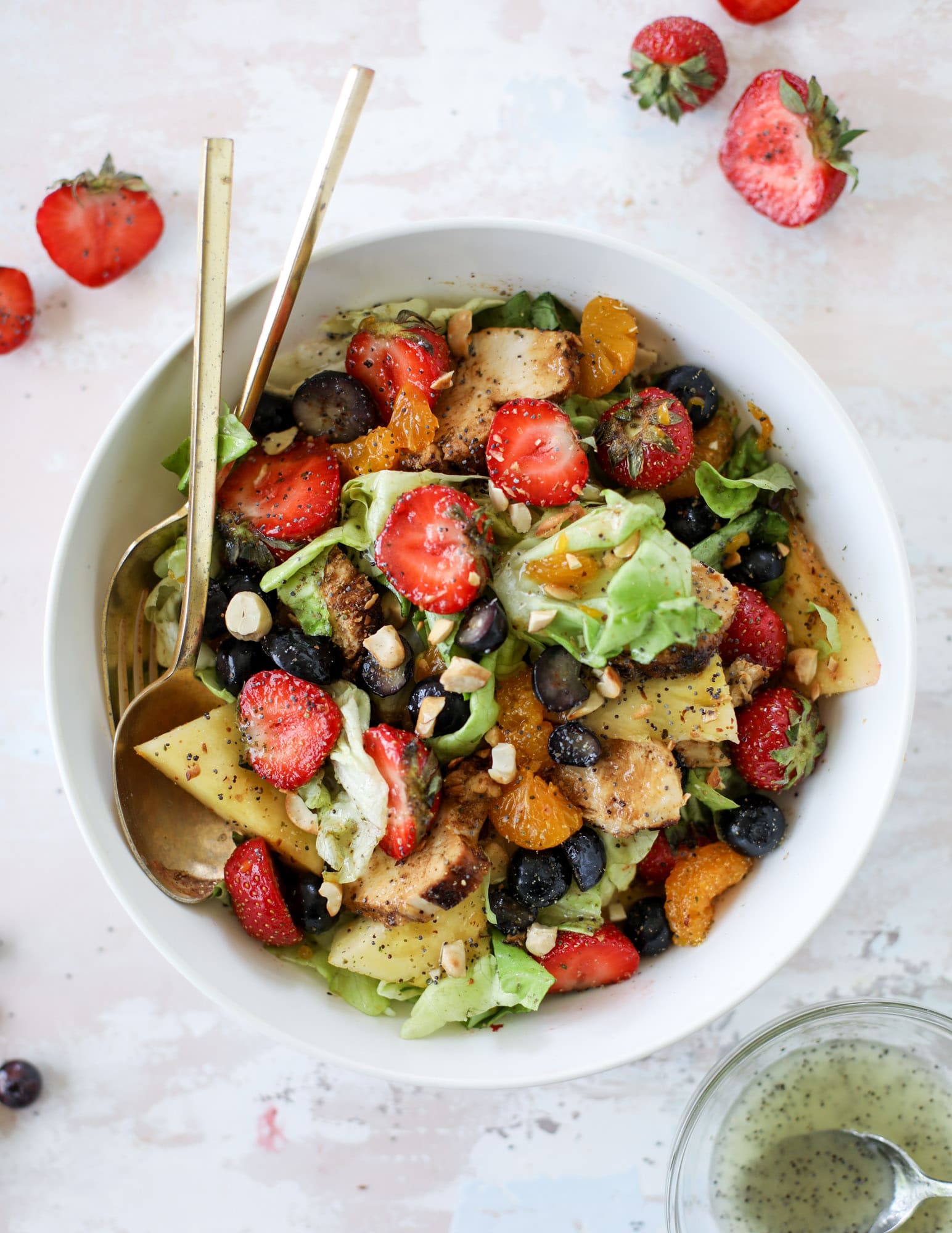 This copycat Panera strawberry poppyseed salad is absolutely delicious and refreshing and perfect for summer! Serve it with grilled chicken like the recipe here or swap for shrimp or fish. I howsweeteats.com #strawberry #poppyseed #salad #chicken #panera #copycat