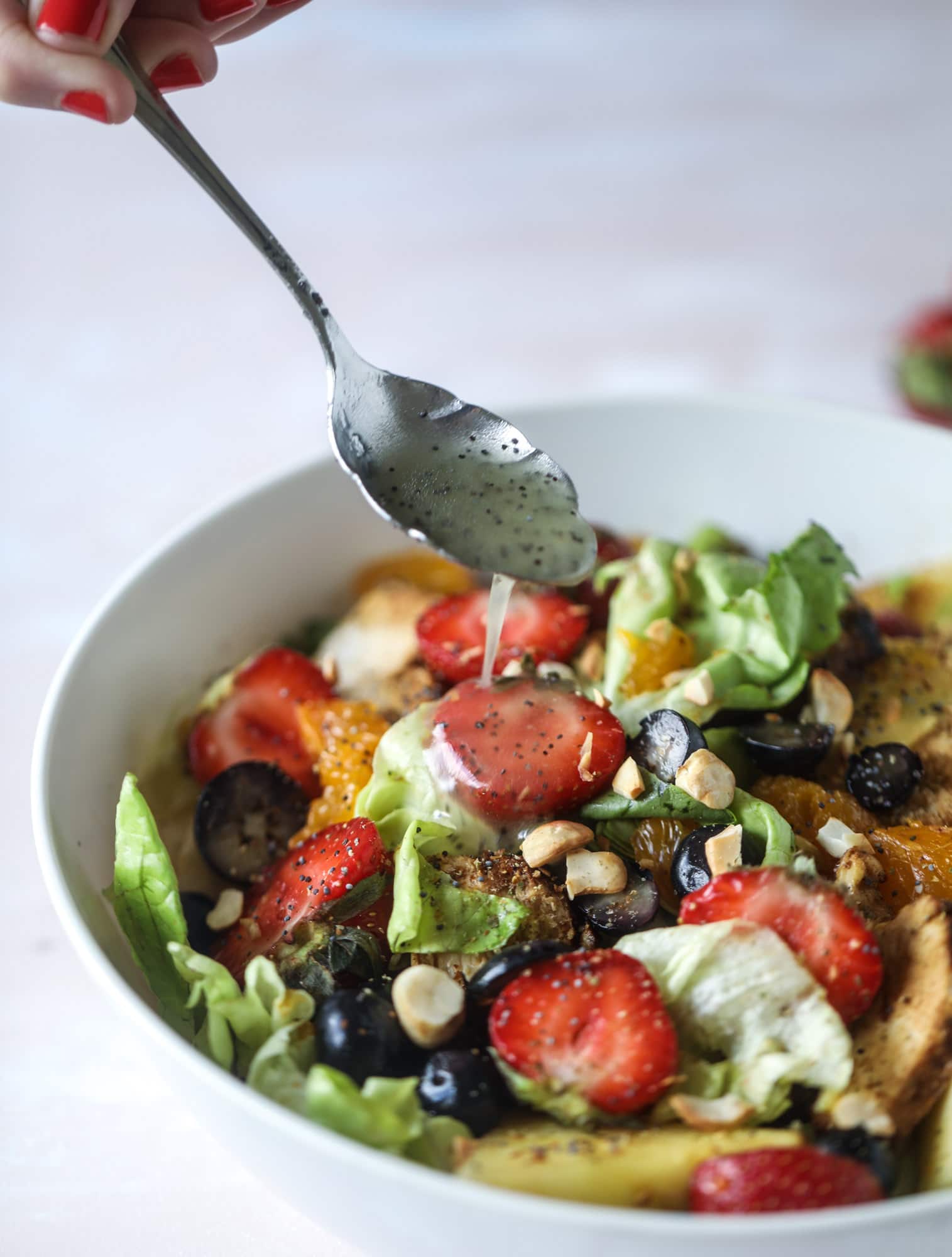 This copycat Panera strawberry poppyseed salad is absolutely delicious and refreshing and perfect for summer! Serve it with grilled chicken like the recipe here or swap for shrimp or fish. I howsweeteats.com #strawberry #poppyseed #salad #chicken #panera #copycat