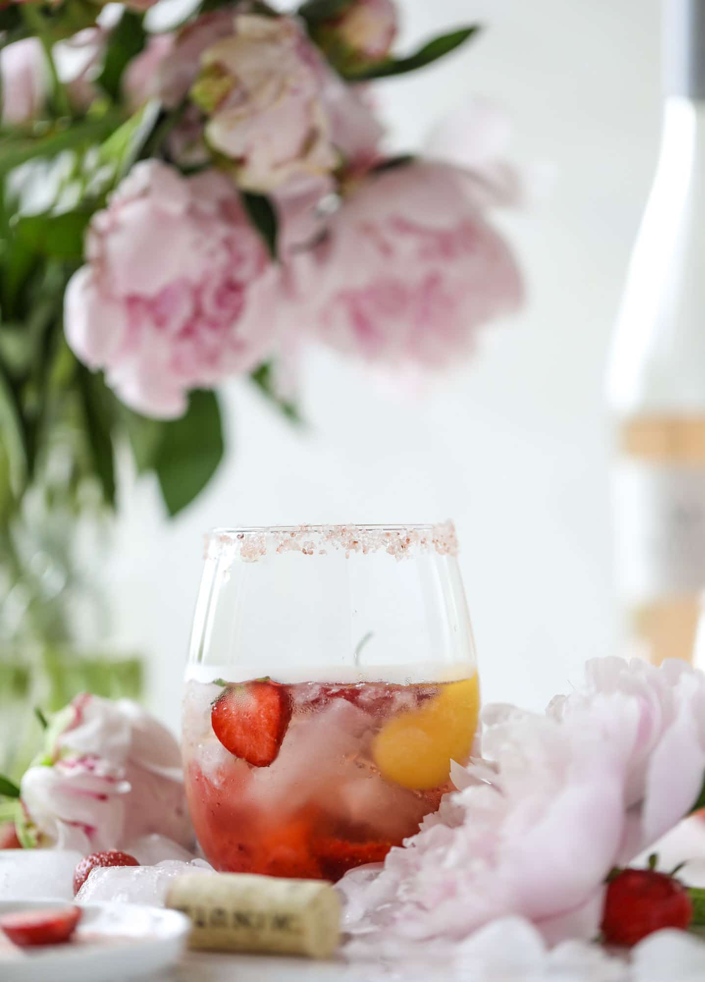 This tequila rosé spritz cocktail is perfectly refreshing for hot summer nights. A mix between a margarita and spritzer, this starts with muddled strawberries and honey, a shot of tequila and is topped off with your favorite rosé wine! I howsweeteats.com #tequila #rosé #wine #spritz #cocktail #strawberries