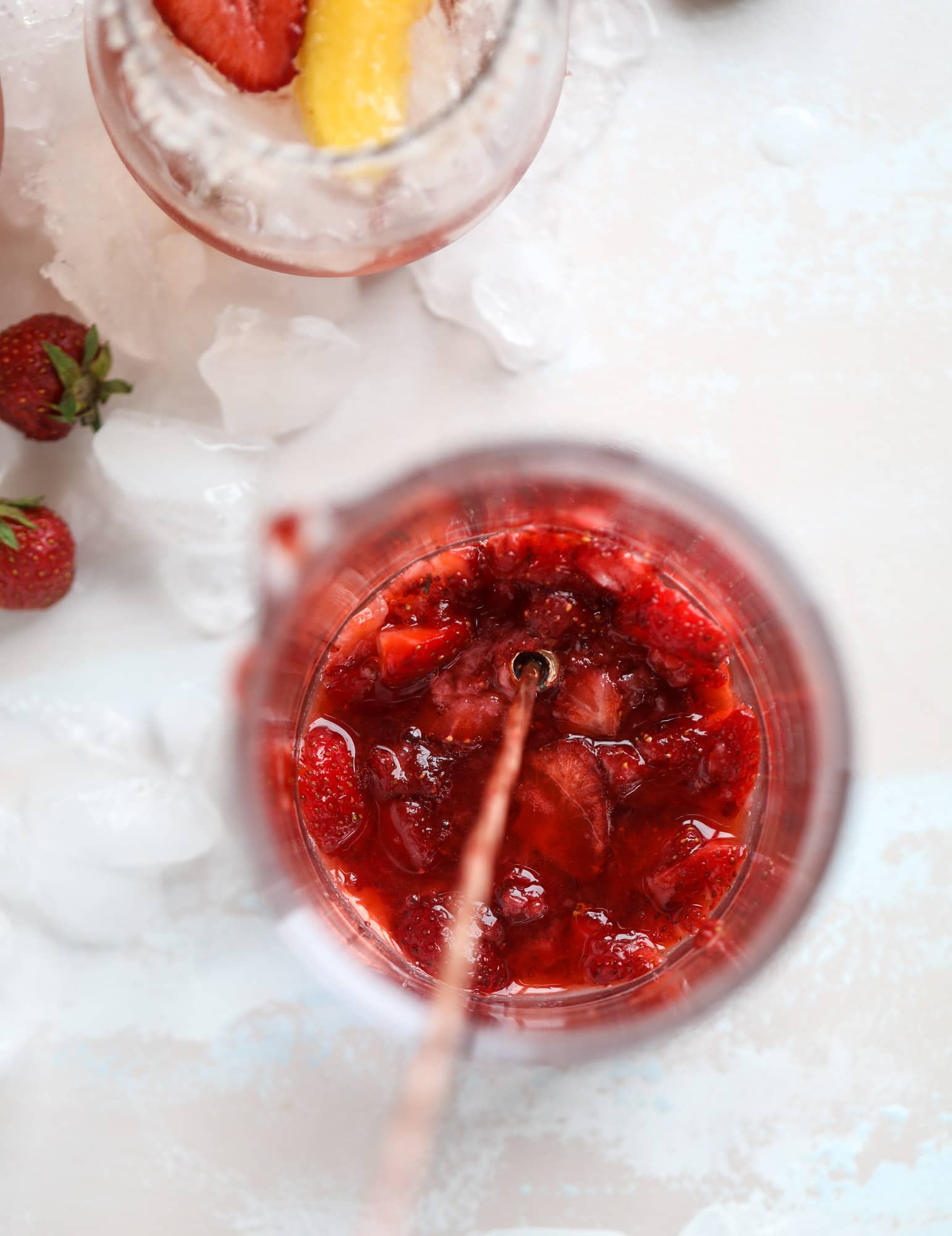 This tequila rosé spritz cocktail is perfectly refreshing for hot summer nights. A mix between a margarita and spritzer, this starts with muddled strawberries and honey, a shot of tequila and is topped off with your favorite rosé wine! I howsweeteats.com #tequila #rosé #wine #spritz #cocktail #strawberries