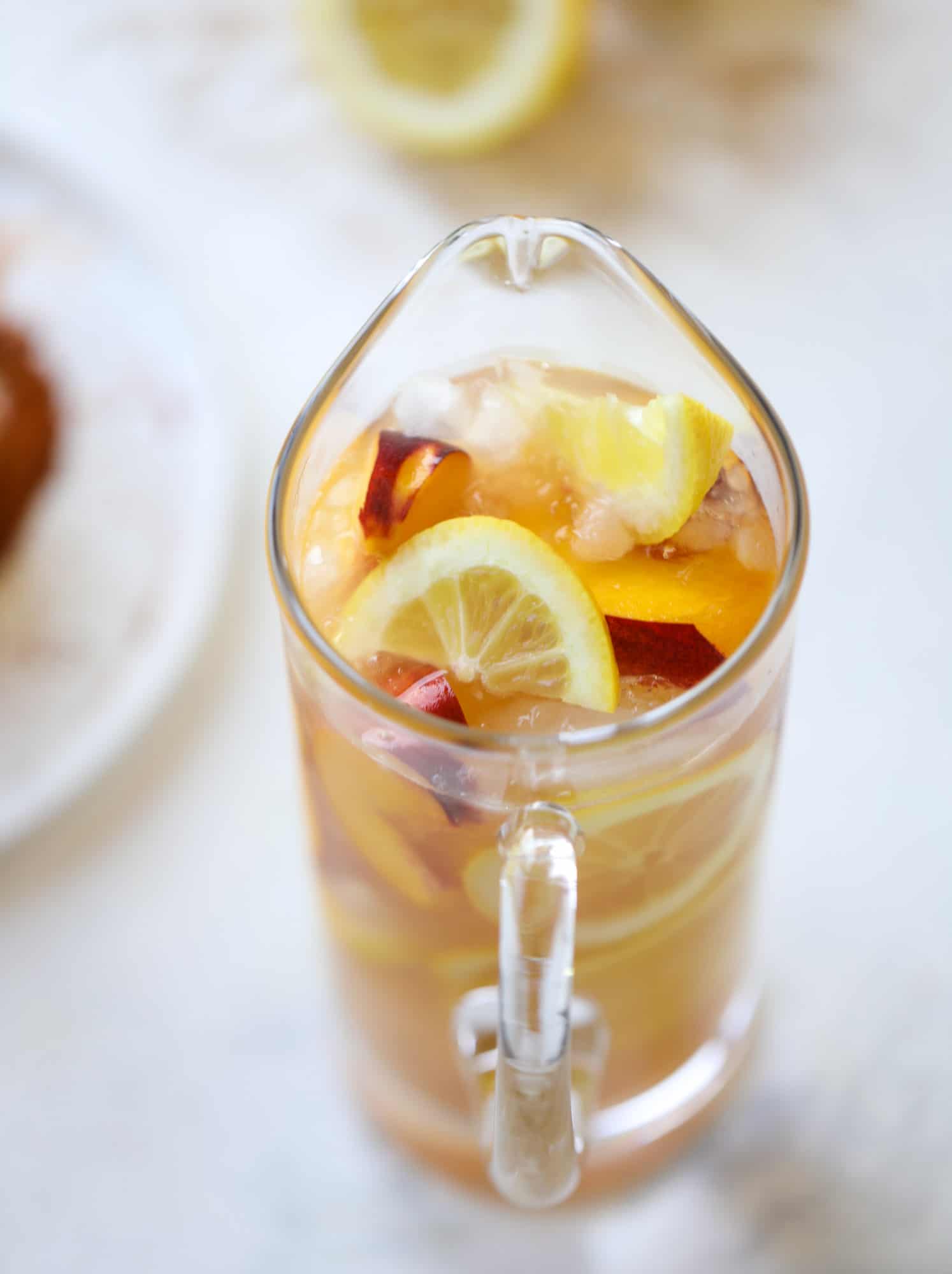 This peach lemonade is super refreshing and a bit spicy for a hot and sunny summer day. It's sweet and fresh and the rim is dipped in a cajun seasoning, bringing the best bite of heat to this perfect summer drink. So fresh! I howsweeteats.com #peach #lemonade #cajun #summer #mocktail #lemon #drink