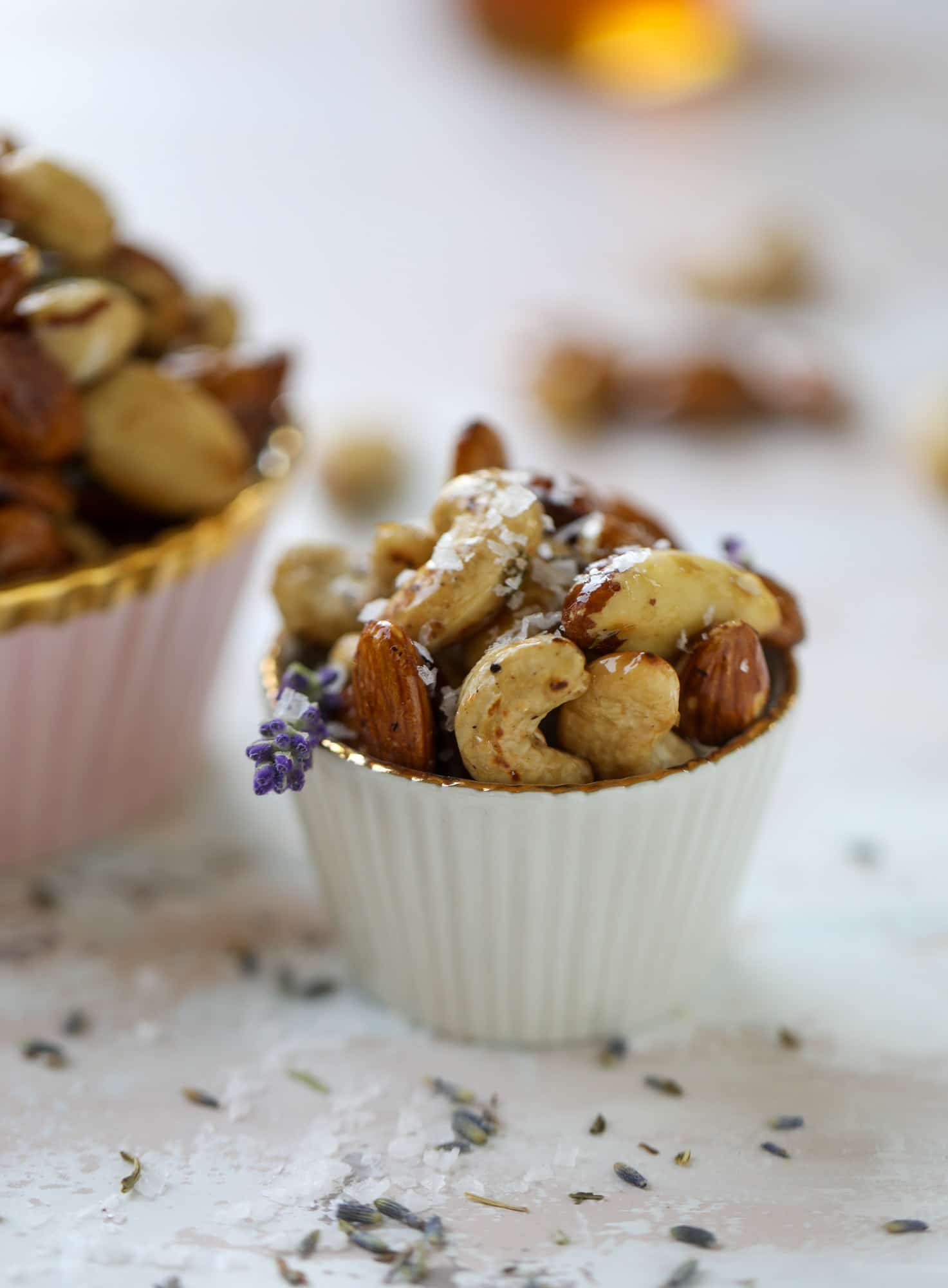 These salted honey lavender nuts are the best snack to make for when you're on the go or when you need a perfect appetizer for your dinner party. Roasted, sweet and salty with a hint of lavender makes these irresistible! I howsweeteats.com #honey #lavender #nuts #salted #almonds #cashews #snacks #appetizers