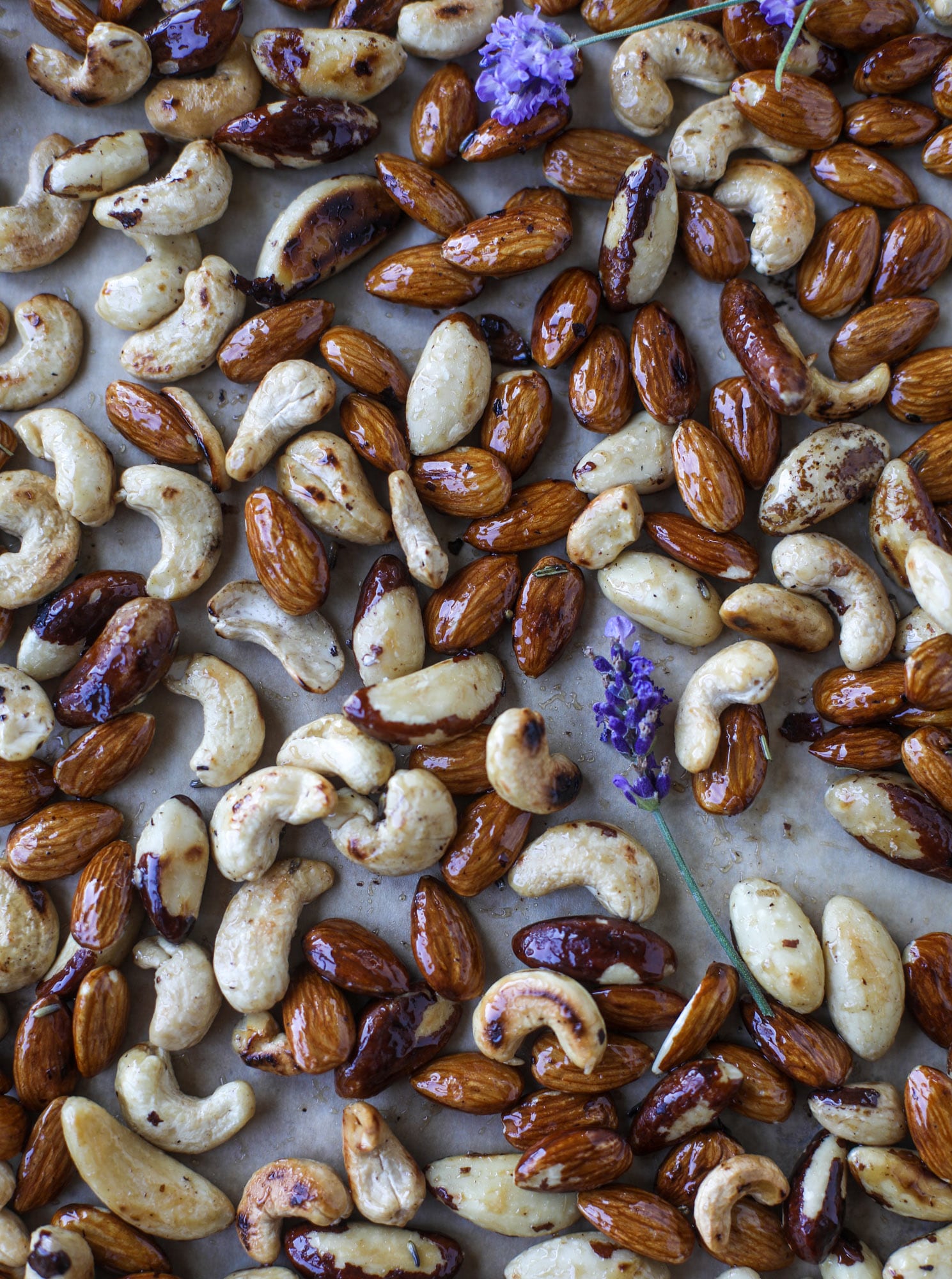These salted honey lavender nuts are the best snack to make for when you're on the go or when you need a perfect appetizer for your dinner party. Roasted, sweet and salty with a hint of lavender makes these irresistible! I howsweeteats.com #honey #lavender #nuts #salted #almonds #cashews #snacks #appetizers