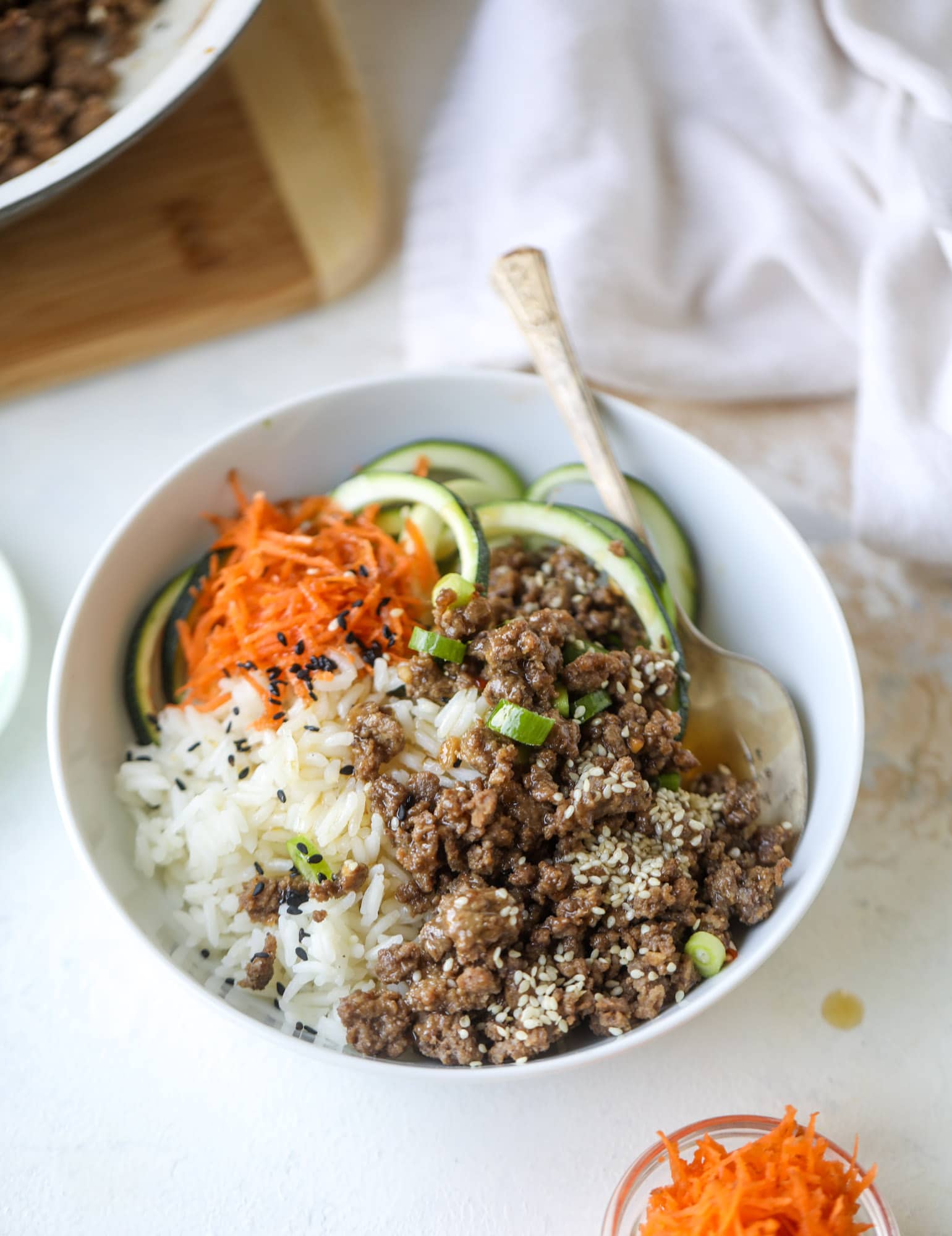 These korean beef bowls are so packed full of flavor that you won't want to eat anything else! Serve the beef with zucchini noodles, grated carrot and jasmine rice for a satisfying, flavor-packed bowl that comes together easily and quick! I howsweeteats.com #korean #beef