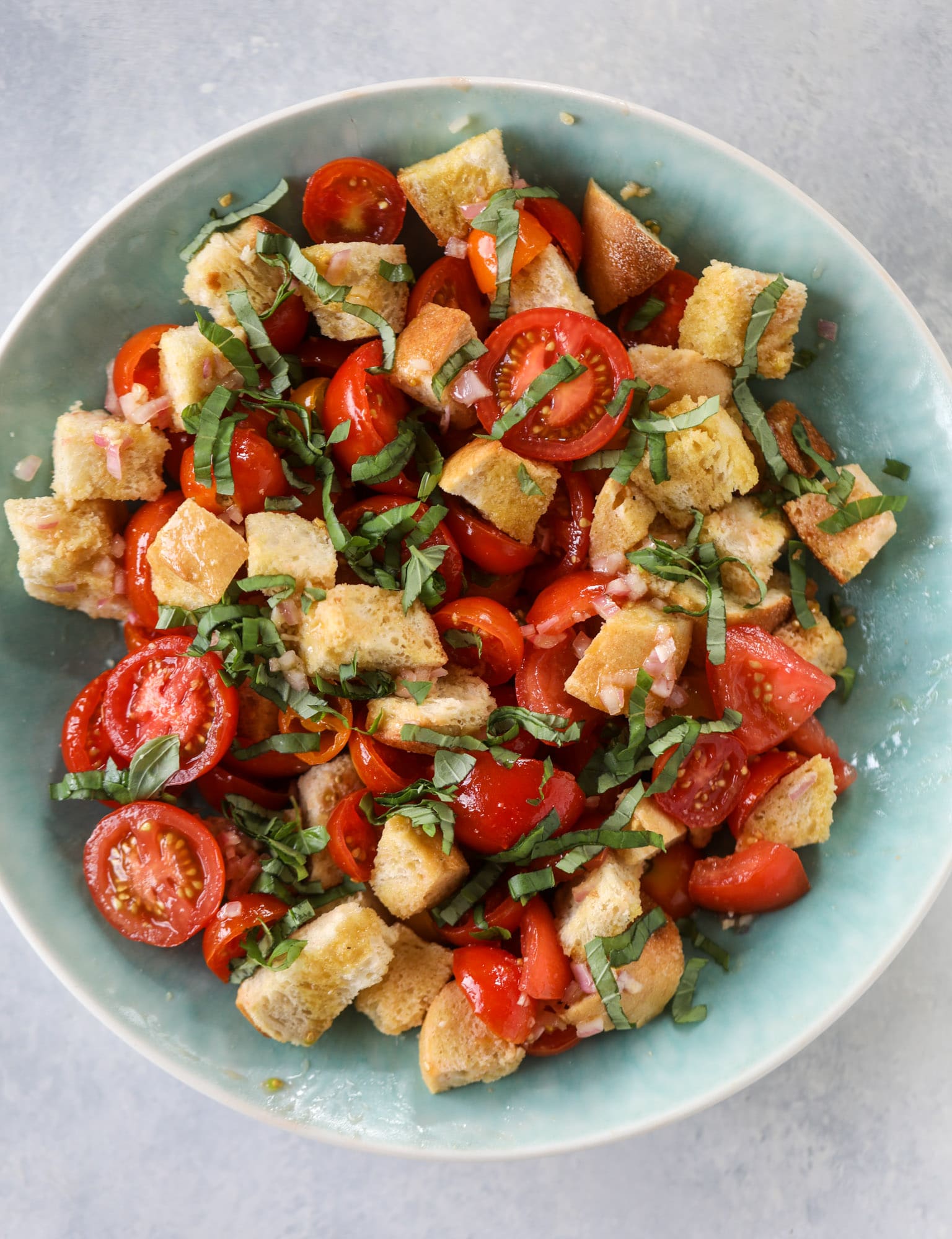 This is the perfect tomato panzanella salad! It's full of juicy, bursting, sweet tomatoes, toasted sourdough bread cubes, fresh herbs, grilled corn, sliced avocado and an incredible homemade dressing that blankets everything in deliciousness. SO good. I howsweeteats.com #panzanella #salad #tomato #basil #summer #corn #avocado #healthy #recipes