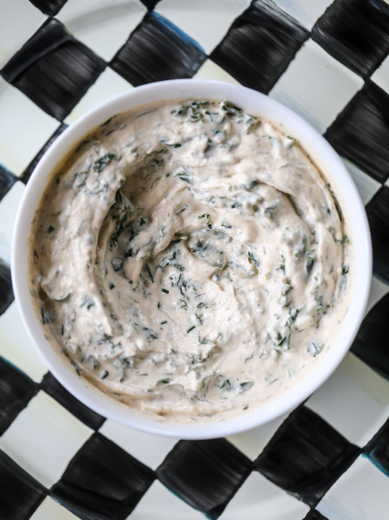 This greek yogurt ranch dip is fabulous for a summertime pool tip and it's full of greens! Made with a homemade ranch spice seasoning, lots of shredded greek kale and greek yogurt, it's the perfect dip for crudite or chips! I howsweeteats.com #kale #greek #yogurt #ranch #dip #healthy #snacks