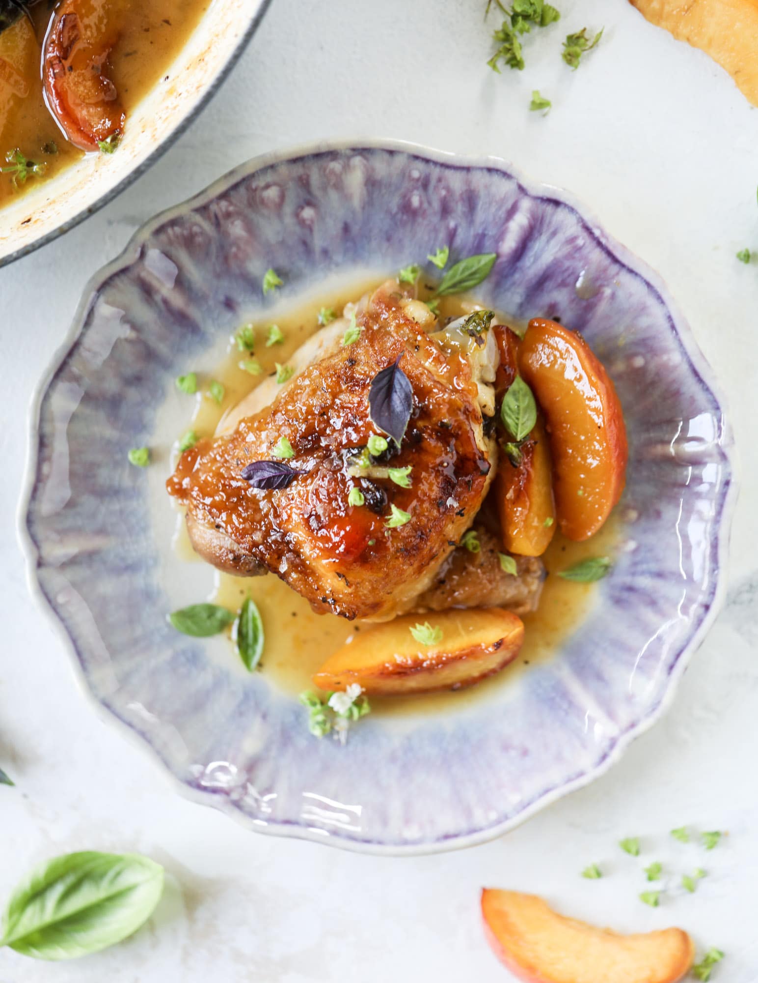 This amazing summertime one pot chicken is made with fresh peaches and basil and takes no time at all. The sweet and savory combination is perfect for a quick weeknight meal; the sauce is amazing for dipping and the chicken is flavorful as can be. I howsweeteats.com #chicken #peach #basil #easy #dinner #recipe #summer #healthy