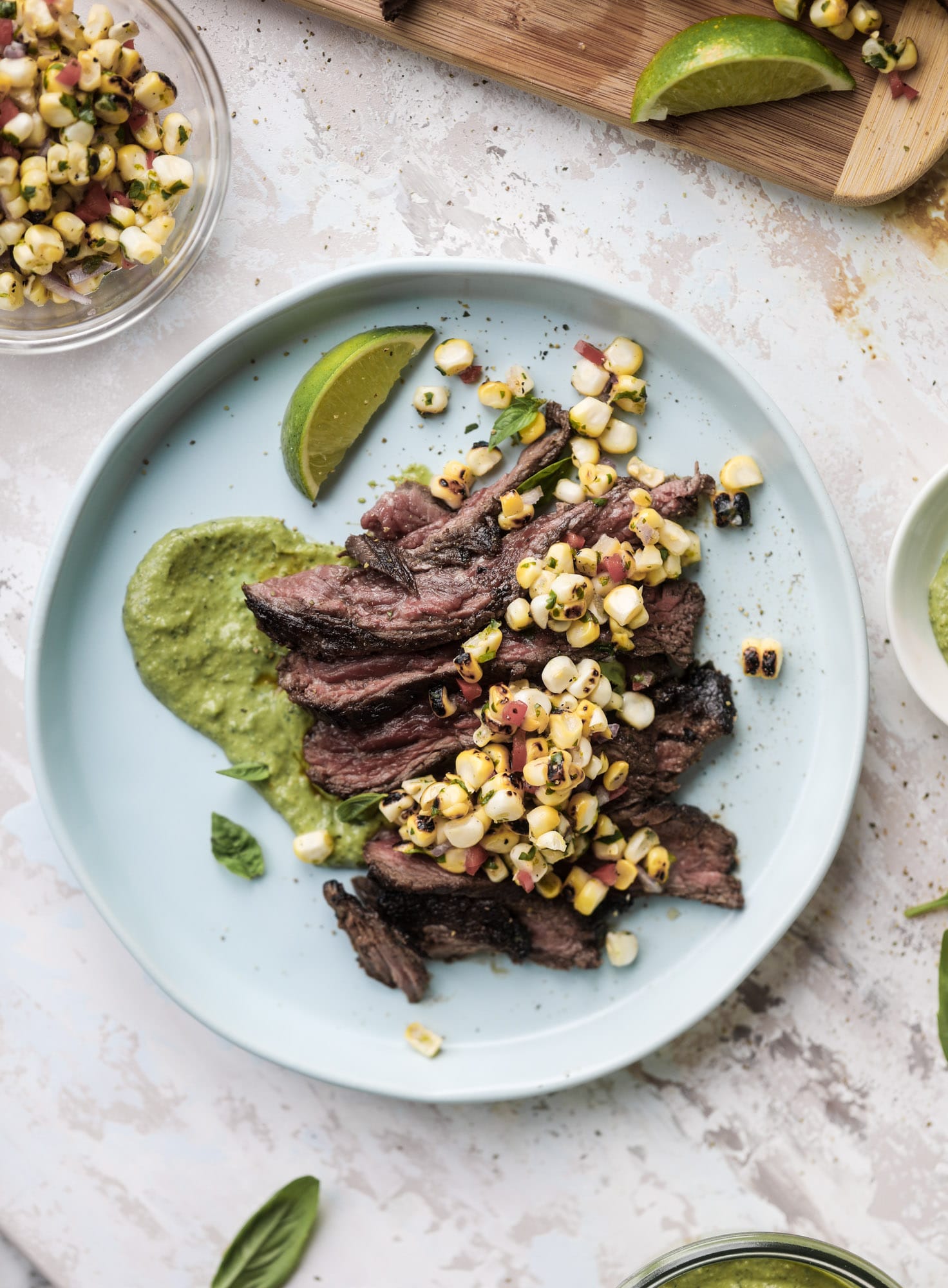 This skirt steak recipe is so super easy and delicious! Marinate it for a bit, prepare it to your liking then serve it with the most flavorful avocado pesto and grilled corn relish. Feels like a fancy restaurant meal and will make you love skirt steak forever! I howsweeteats.com #skirt #steak #avocado #pesto #corn #relish #recipes
