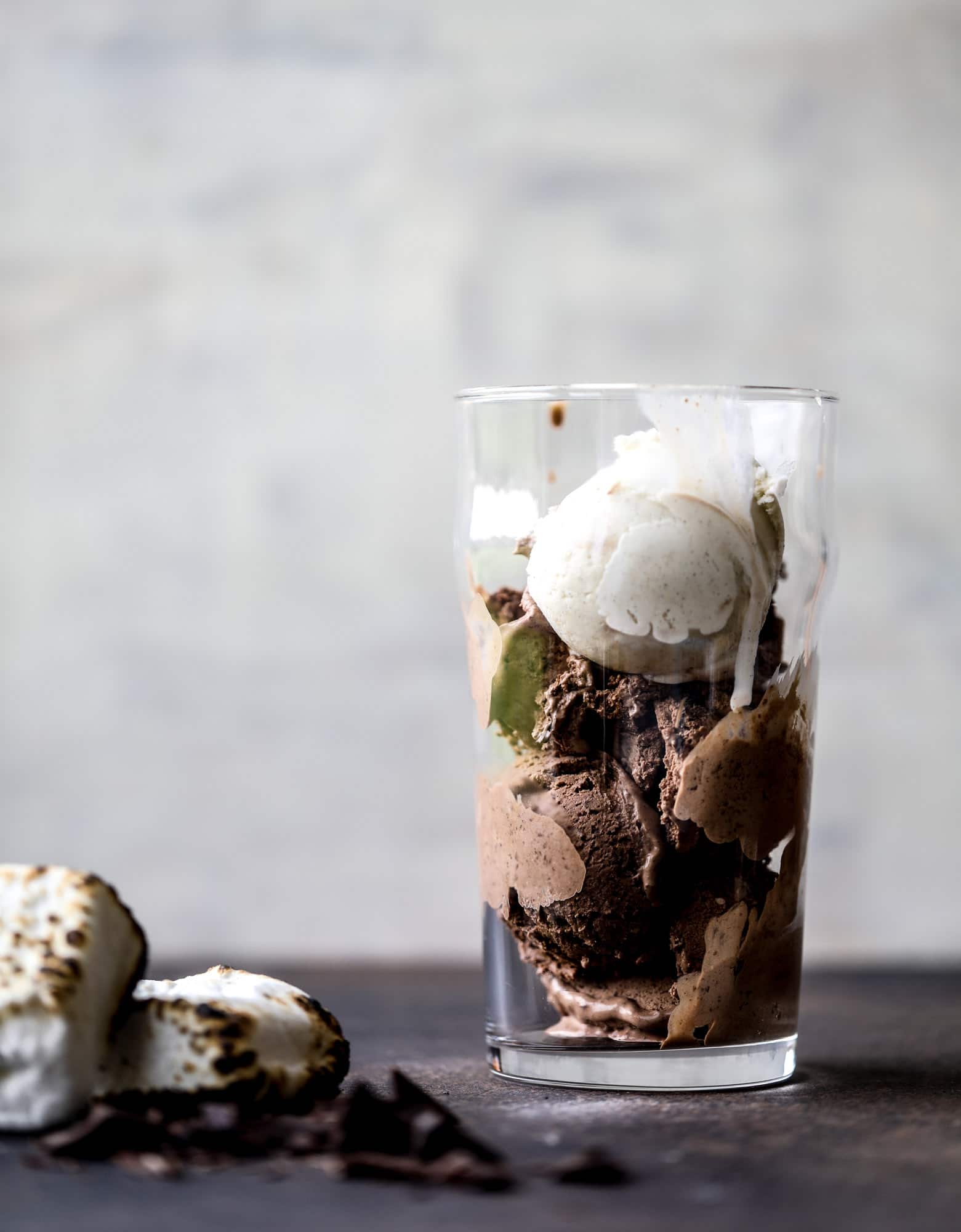 This is the most perfect root beer float, complete with both chocolate and vanilla ice creams. Topped with a smoky s'more, a chocolate fudge rim and a sprinkle of graham cracker crumbs take this super fun drink over the top! I howsweeteats.com #root #beer #float #summer #s'mores #drinks