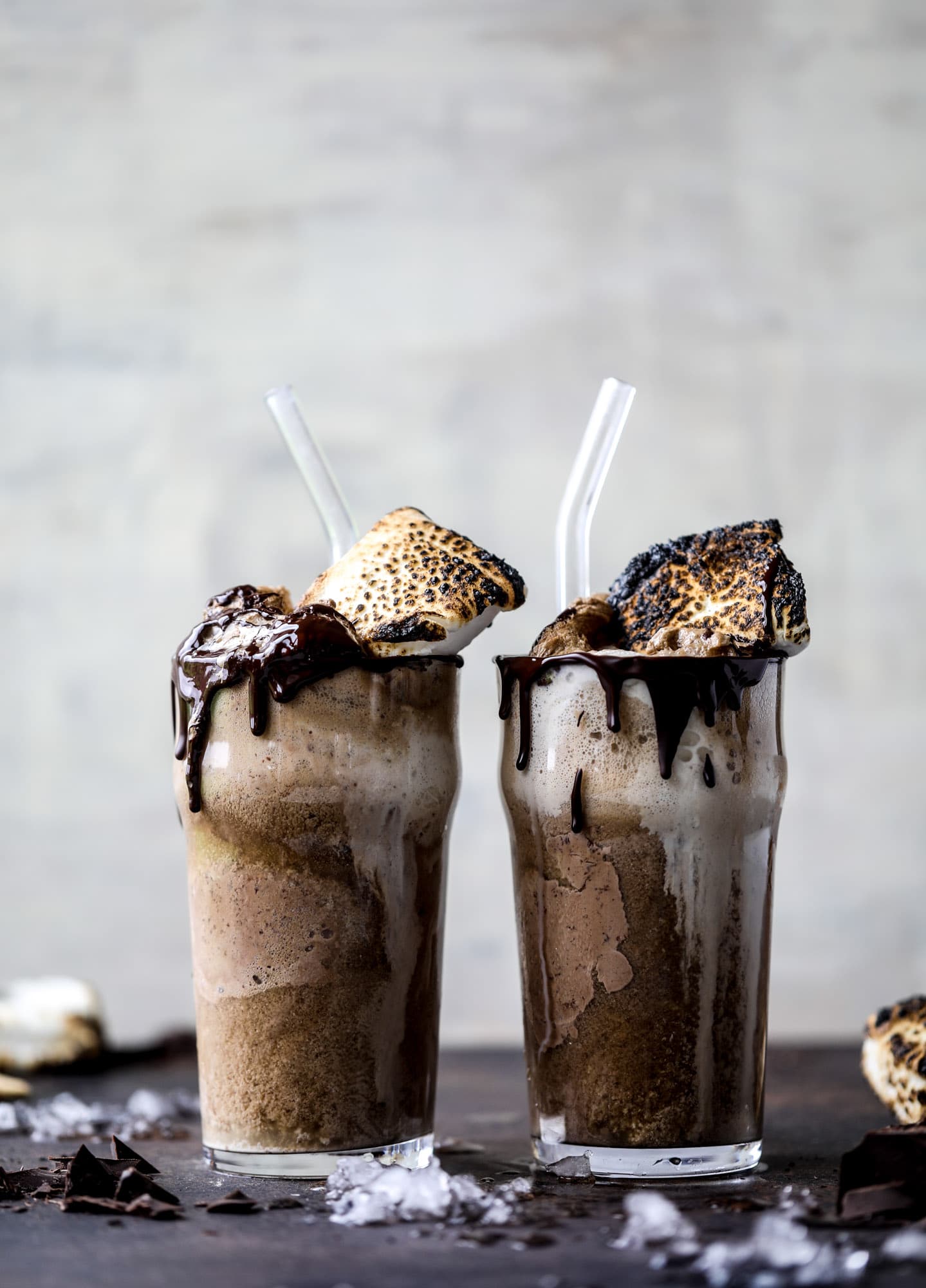 This is the most perfect root beer float, complete with both chocolate and vanilla ice creams. Topped with a smoky s'more, a chocolate fudge rim and a sprinkle of graham cracker crumbs take this super fun drink over the top! I howsweeteats.com #root #beer #float #summer #s'mores #drinks