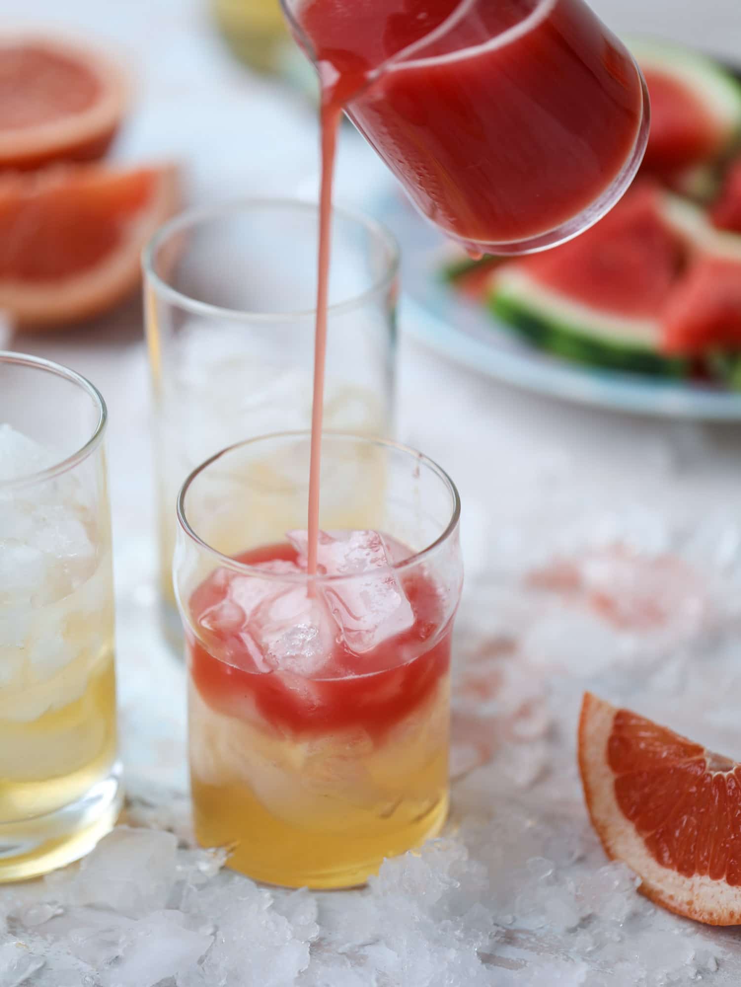 This watermelon grapefruit paloma cocktail is a summertime dream! Grapefruit syrup is super easy to make and when it's combined with fresh watermelon juice and tequila... oooh! Best happy hour ever. I howsweeteats.com #grapefruit #watermelon #paloma #cocktail #tequila
