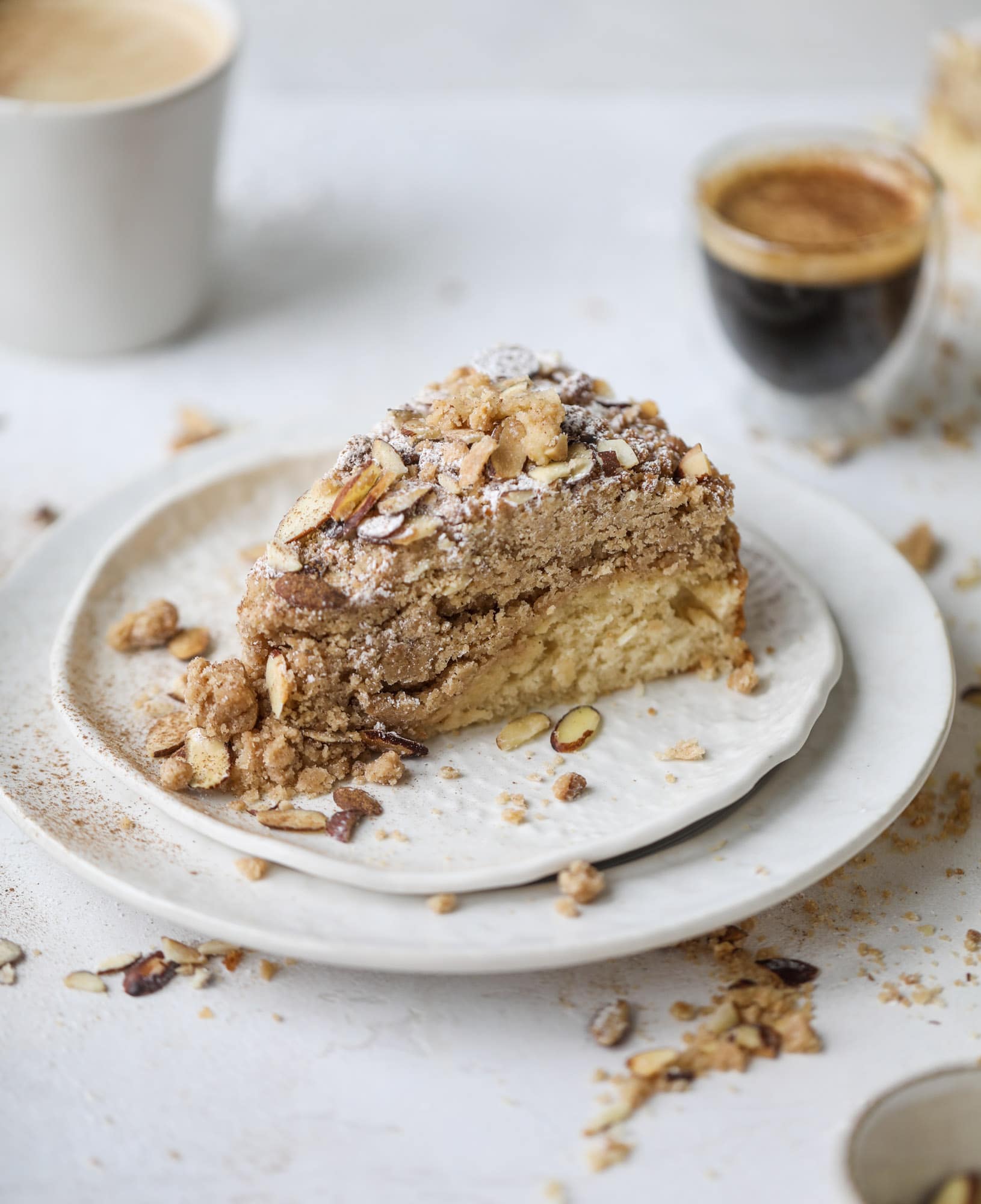 This almond crumb cake is so delicious and perfect for breakfast or dessert! It's full of delicious almond flavor and crunch and the crumb on top is so thick and perfect. It's like an almond croissant on steroids. I howsweeteats.com #almond #crumb #cake