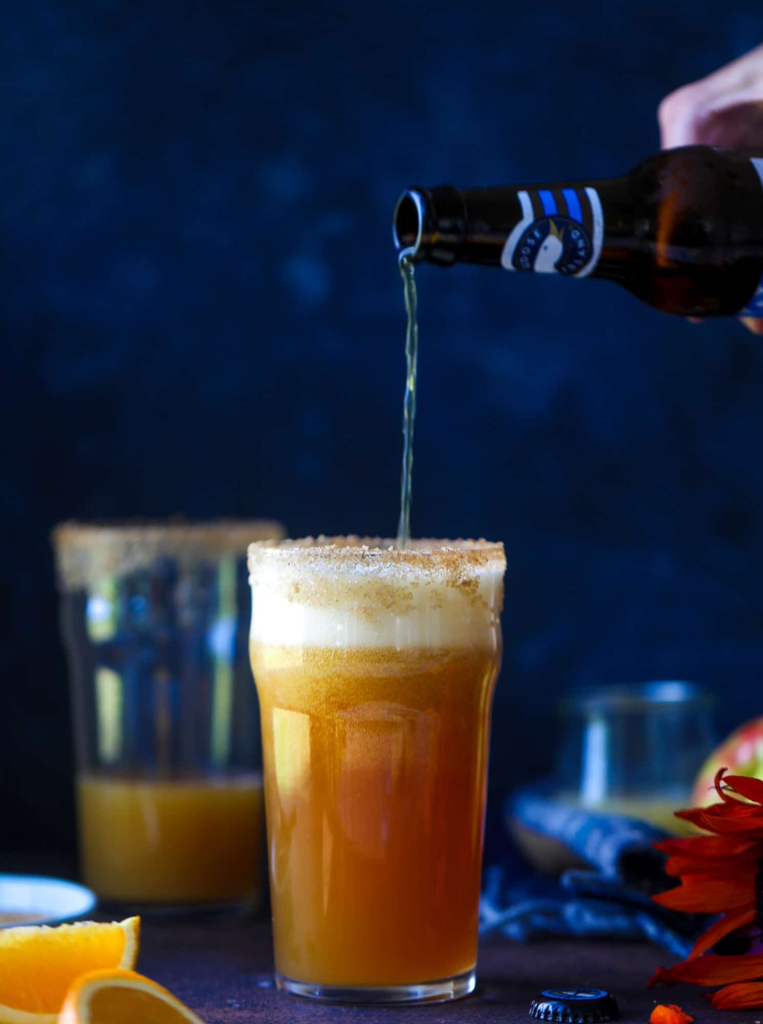 This apple cider shandy recipes is perfect for the fall season! Apple cider, sparkling cider and your favorite beer come together in an icy glass to create the best flavor ever. Finished with a cinnamon sugar rim, there's nothing better! I howsweeteats.com #apple #cider #shandy #cocktails #beer