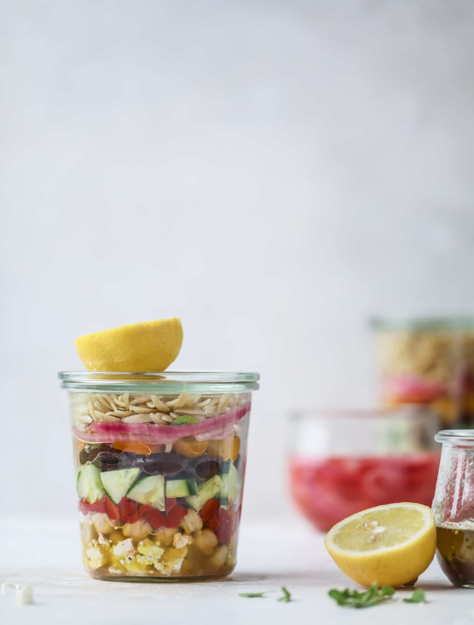 This incredible greek orzo salad in a jar is to die for! The recipe is so easy and flavorful, super satisfying and perfect for meal prep. This salad in a jar is a delicious lunch idea for the weekdays and keeps you feeling full and happy! I howsweeteats.com #salad #jar #greek #orzo #recipes #healthy #lunch #mealprep