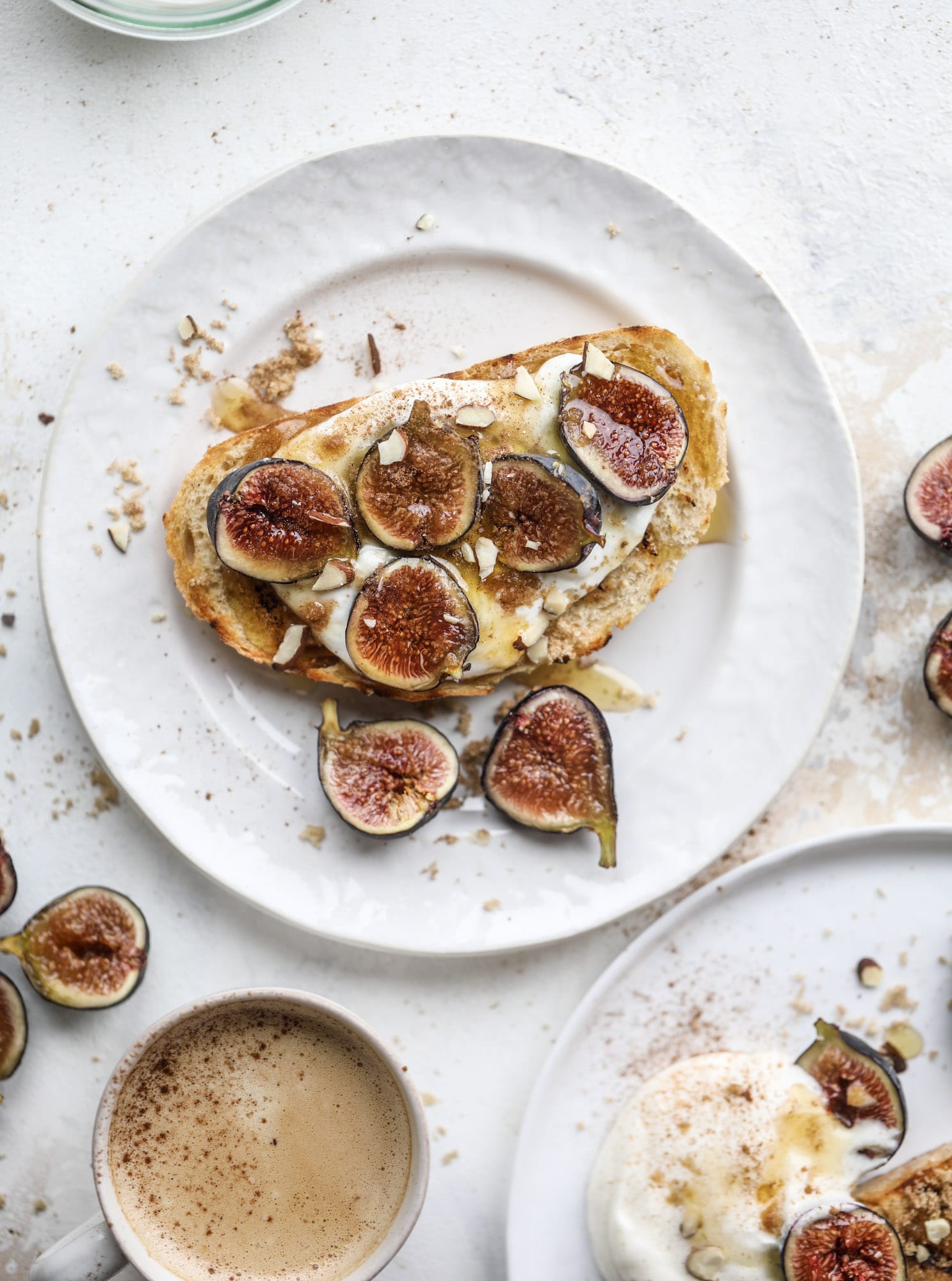 This cinnamon sugar toast is an absolutely dream! It's spread with a cinnamon brown sugar butter, grilled to perfection and served with creamy whipped ricotta cheese, fresh figs, honey, cinnamon and sliced almonds. I howsweeteats.com #cinnamon #sugar #toast #ricotta #figs #breakfast