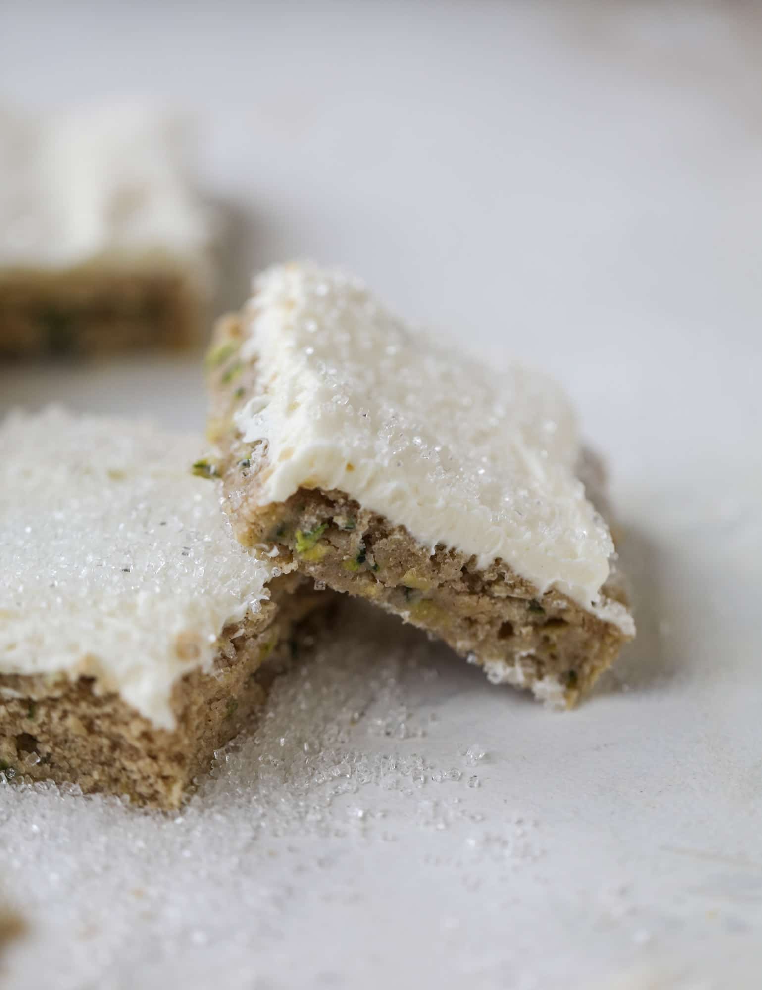 These zucchini bars with cream cheese icing are a fun twist on zucchini bread! Zucchini bars are super easy to make, have a little spice and a lot of flavor, topped with the creamiest cream cheese frosting. Delicious and simple! I howsweeteats.com #zucchini #bars #cream #cheese #icing #dessert