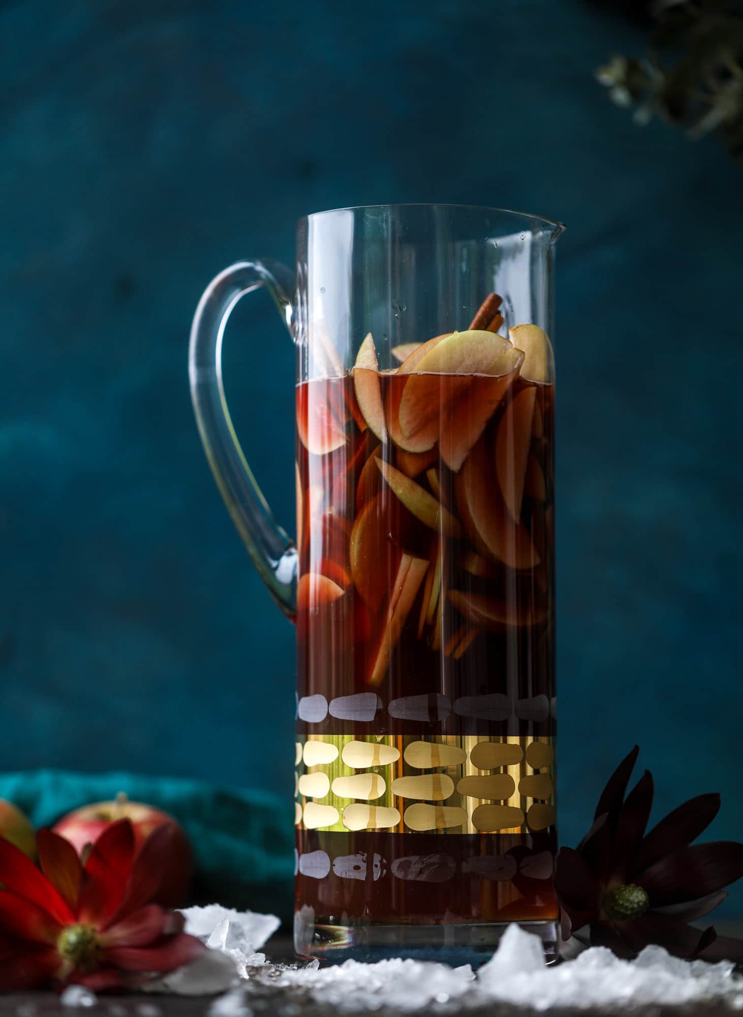 This red apple cider sangria will soon because a staple for your fall! It's delicious and not too sweet, with a base of red wine, apple cider and maple syrup. Cinnamon sticks and apple slices round out the pitcher and it's so flavorful and perfect for the season! I howsweeteats.com #red #apple #cider #sangria 