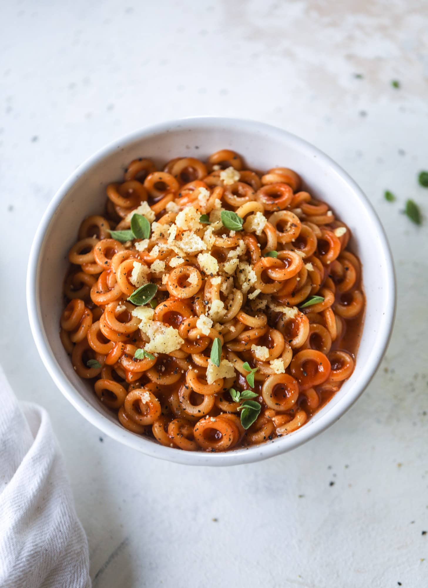 These homemade spaghettios are the ultimate comfort food! They come together in less than 30 minutes, are super easy and flavorful and topped with crispy crunchy manchego cheese that takes the taste over the top! I howsweeteats.com #homemade #spaghettios