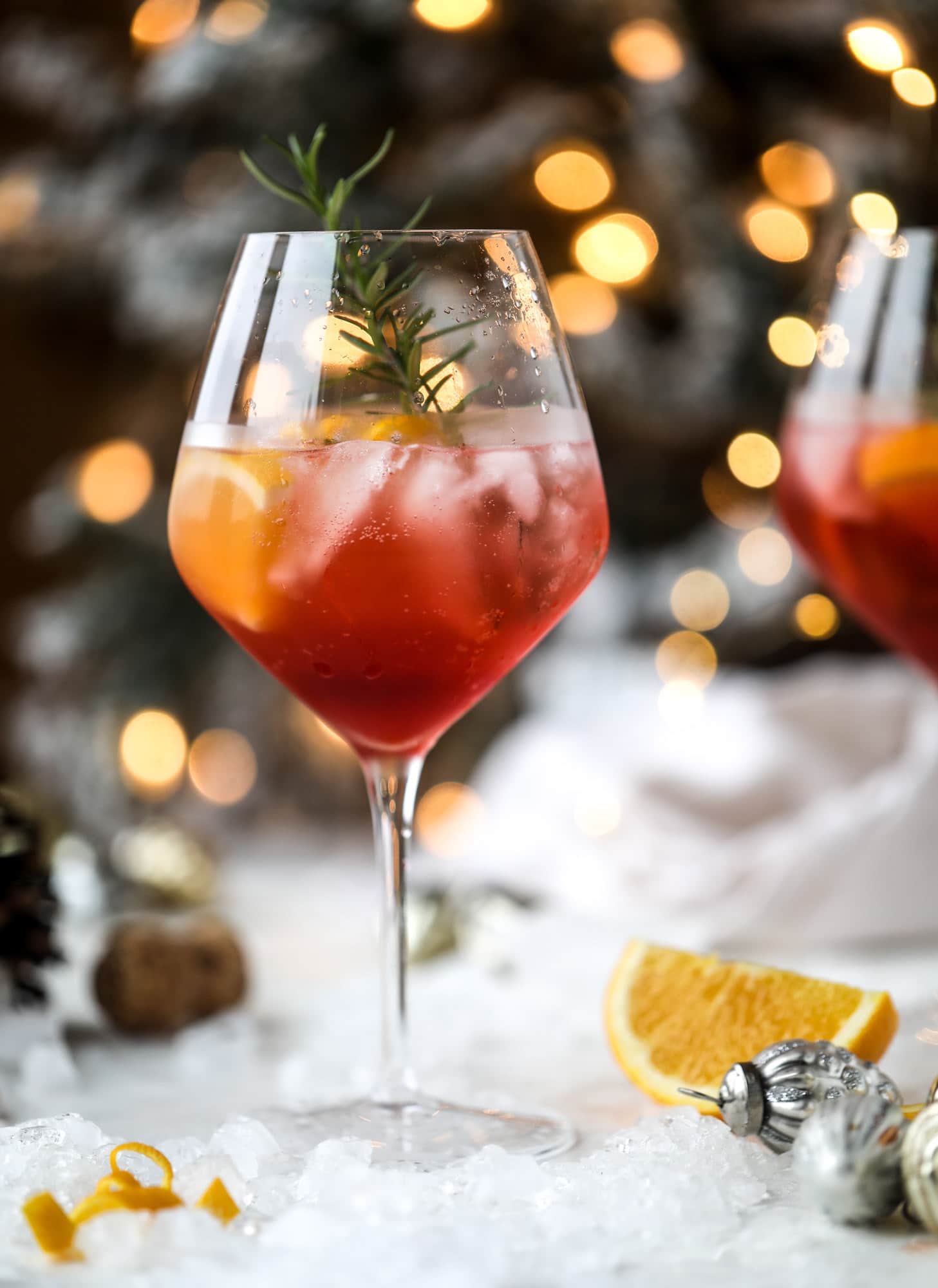 This winter aperol spritz cocktail is a seasonal spin on the classic aperol spritz! Festive cranberry and classic orange come together with prosecco and club soda to create a super light and refreshing cocktail for the holidays! I howsweeteats.com #aperol #spritz