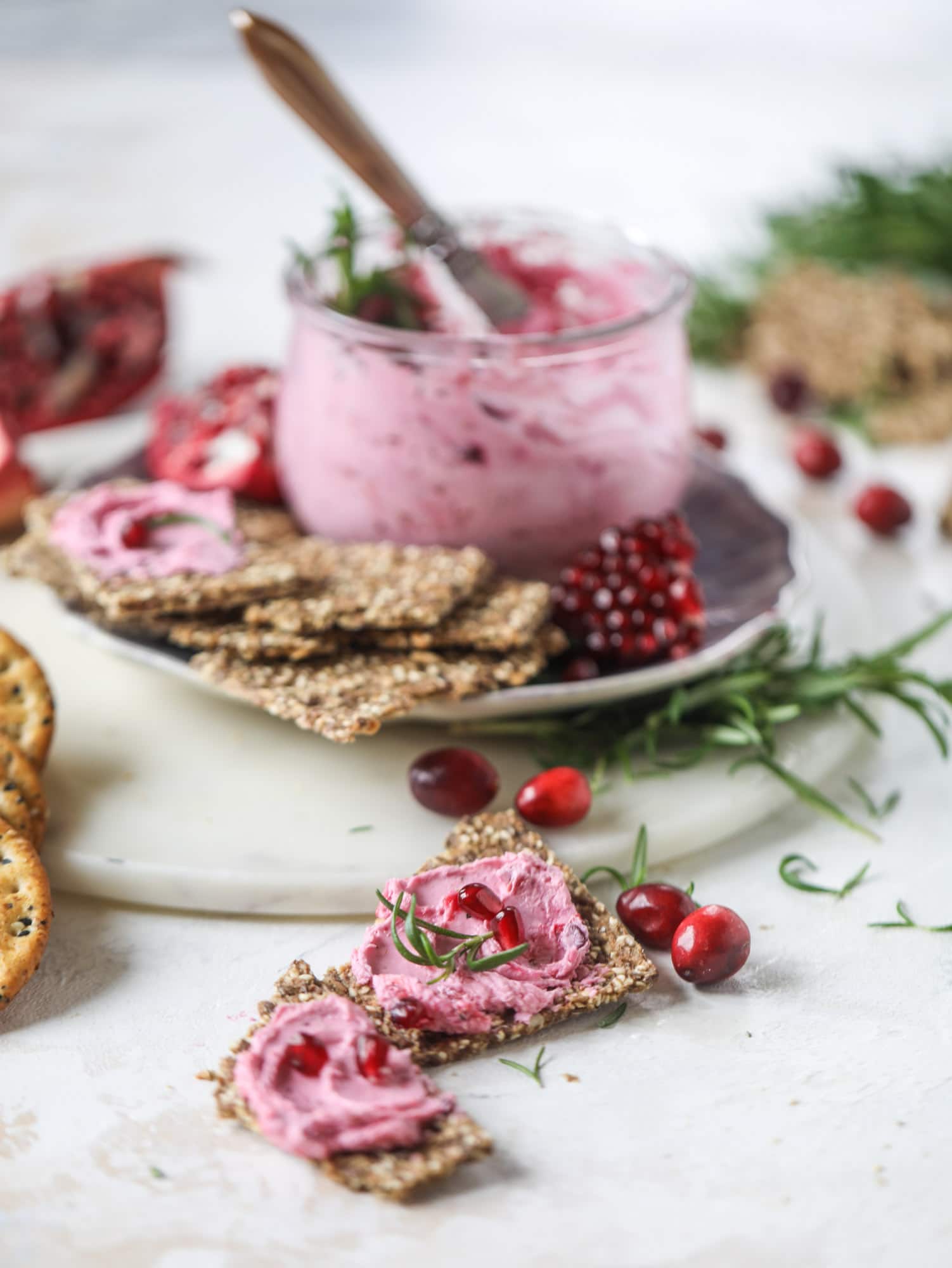 This whipped cranberry goat cheese spread is the perfect holiday appetizer! You can make it ahead of time and serve it with a cheese board or bread and crackers - before or during the meal! Plus it's super pretty too! I howsweeteats.com #cranberry #goatcheese