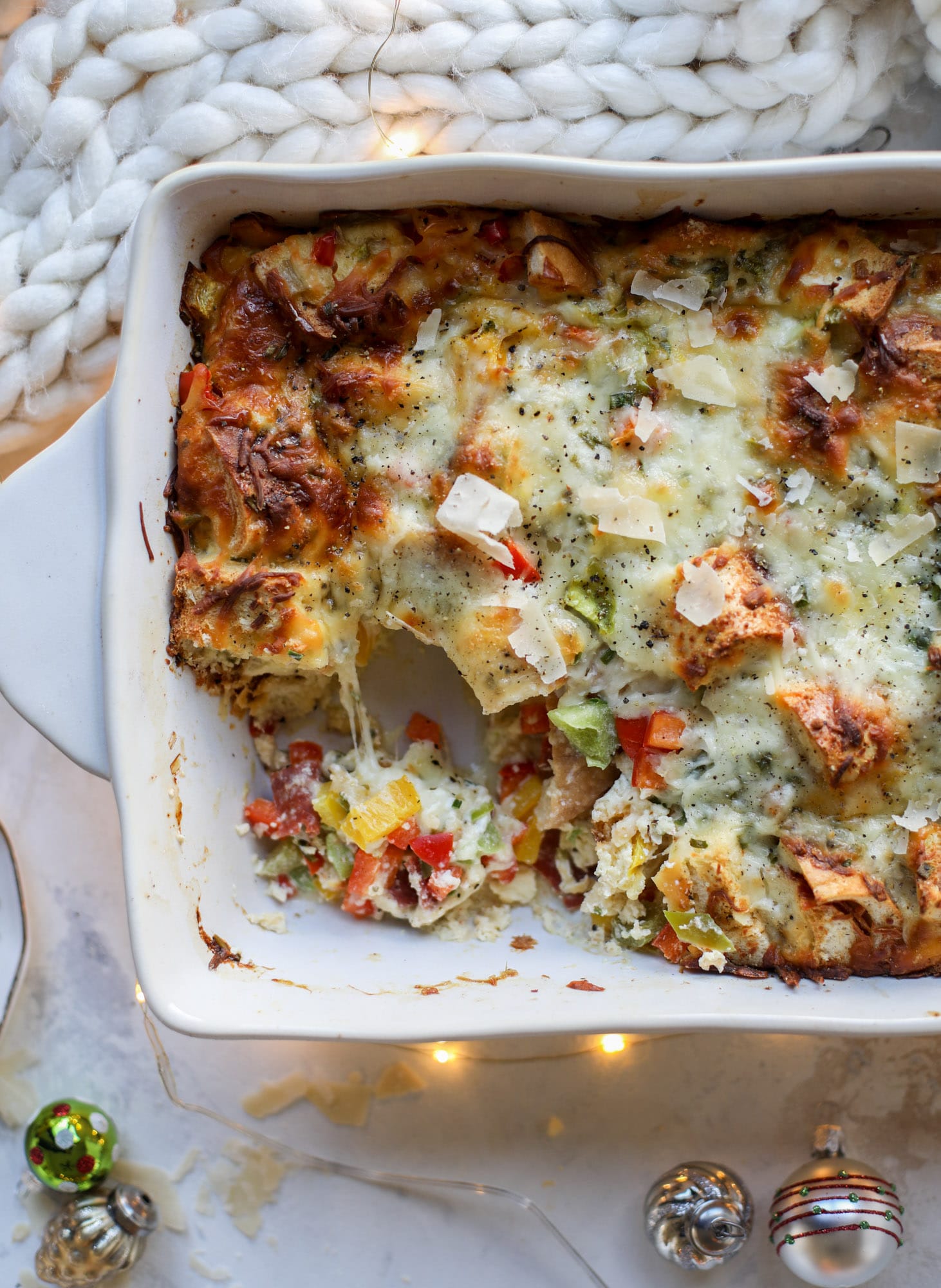This breakfast strata is super special because the base is built on pepperoni rolls! This make ahead casserole is perfect for holiday brunches or parties and tastes like a supreme pizza. It's so easy to throw together too! I howsweeteats.com #breakfast #strata