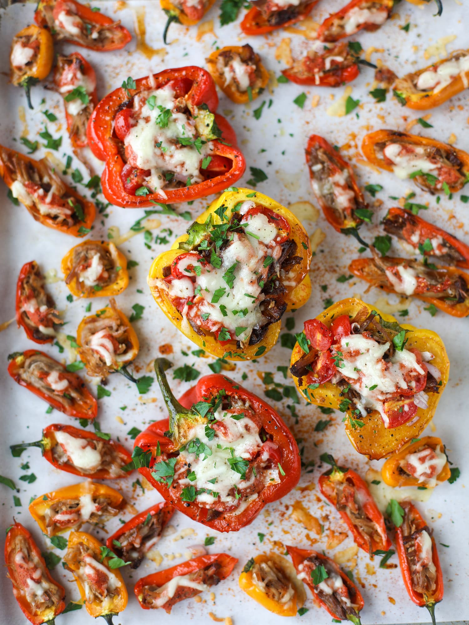 These pulled pork stuffed peppers are a delicious dinner idea for any weeknight! They work great with leftover pulled pork and the filling is totally customizable. They are flavorful, come together quickly and always a crowd pleaser! I howsweeteats.com #pulledpork #stuffedpeppers