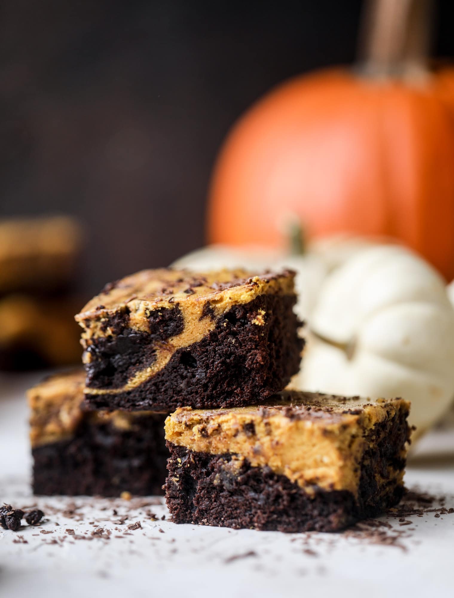 These pumpkin brownies have a fudgy layer of chocolate on the bottom and a silky layer of pumpkin on top! They are so delicious and rich and perfect for fall. The pumpkin brownies come together easily and can be made ahead of time too! I howsweeteats.com #pumpkin #brownies