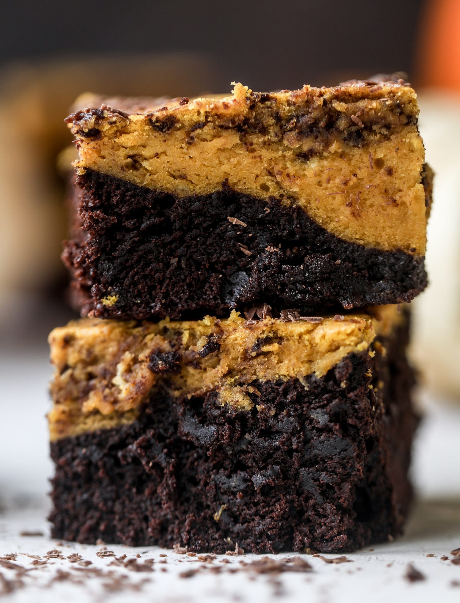 These pumpkin brownies have a fudgy layer of chocolate on the bottom and a silky layer of pumpkin on top! They are so delicious and rich and perfect for fall. The pumpkin brownies come together easily and can be made ahead of time too! I howsweeteats.com #pumpkin #brownies