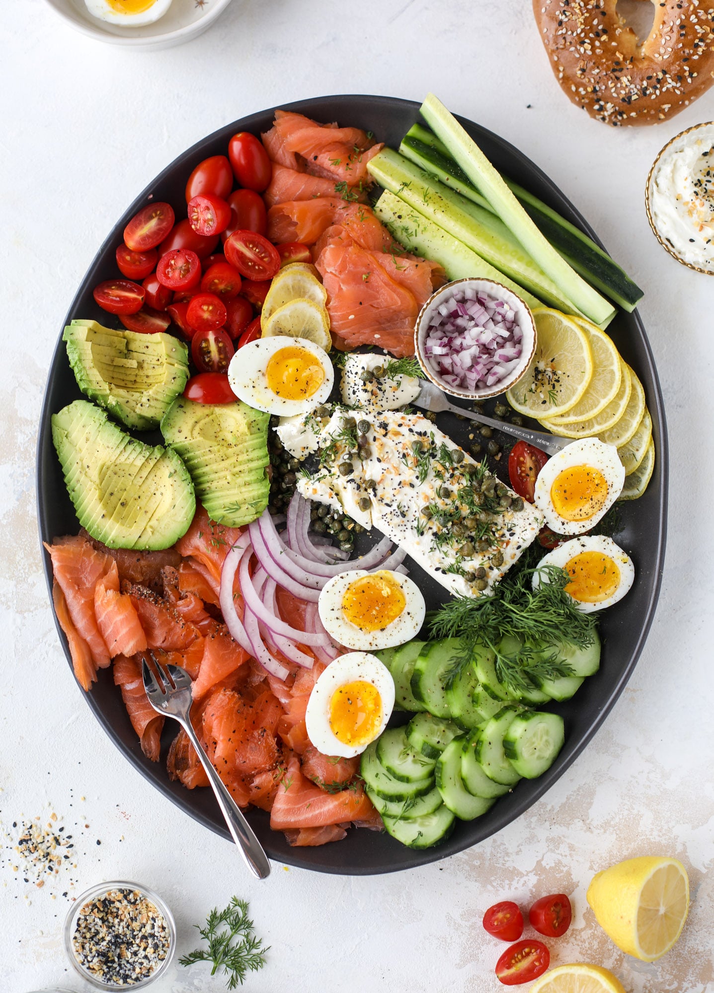 This is my favorite way to make an incredible smoked salmon platter! Fresh smoked salmon with bagels, soft boiled eggs, cream cheese and capers, everything seasoning and so much more. Perfect for holiday breakfasts and brunches! I howsweeteats.com #smokedsalmon #platter