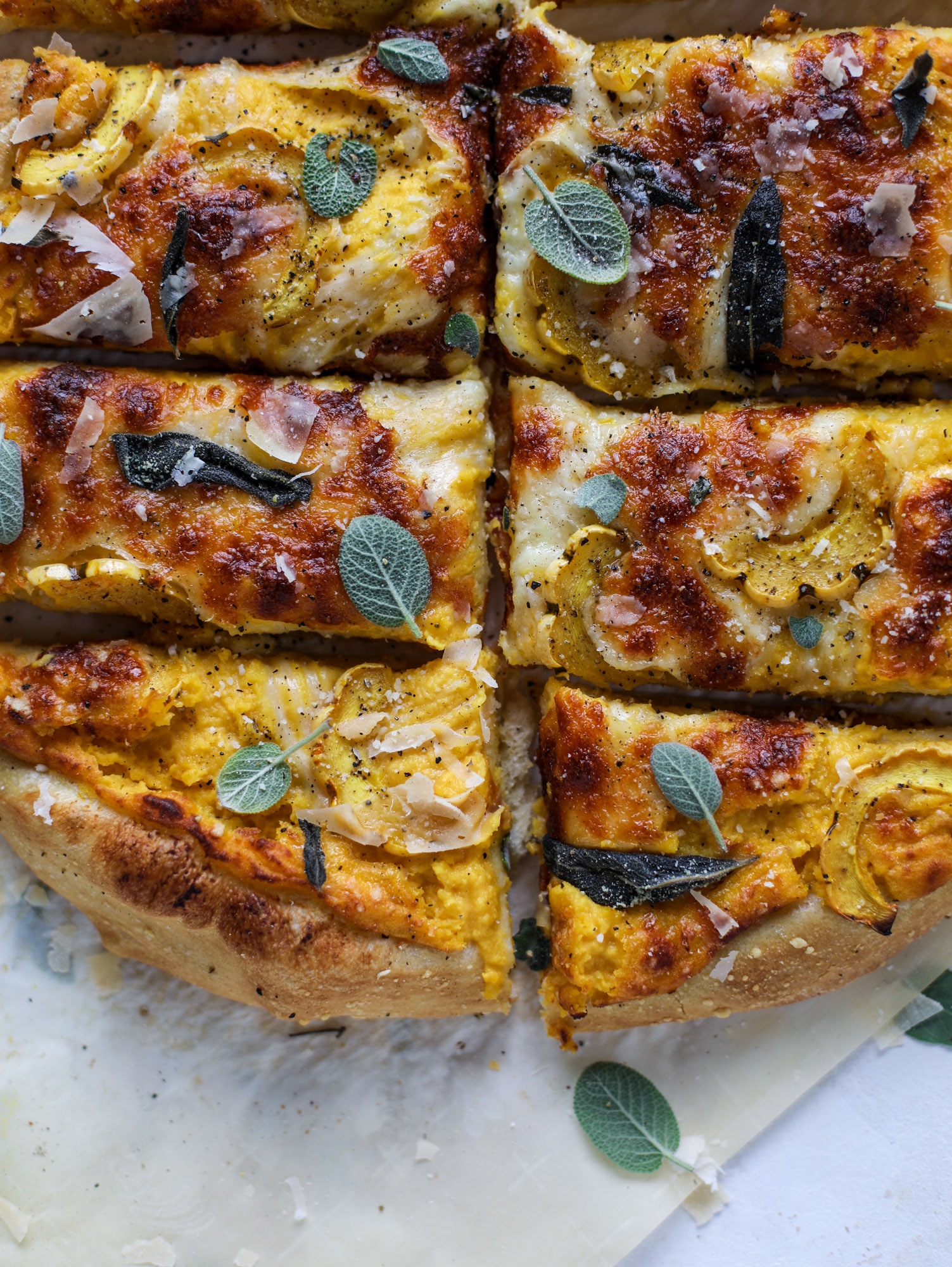 This butternut squash pizza has all the perfect tastes of fall in a pizza! Creamy butternut squash base, sharp parmesan cheese, crispy, fresh sage - it's all these and so super flavorful. It's easy too! I howsweeteats.com #butternutsquash #pizza