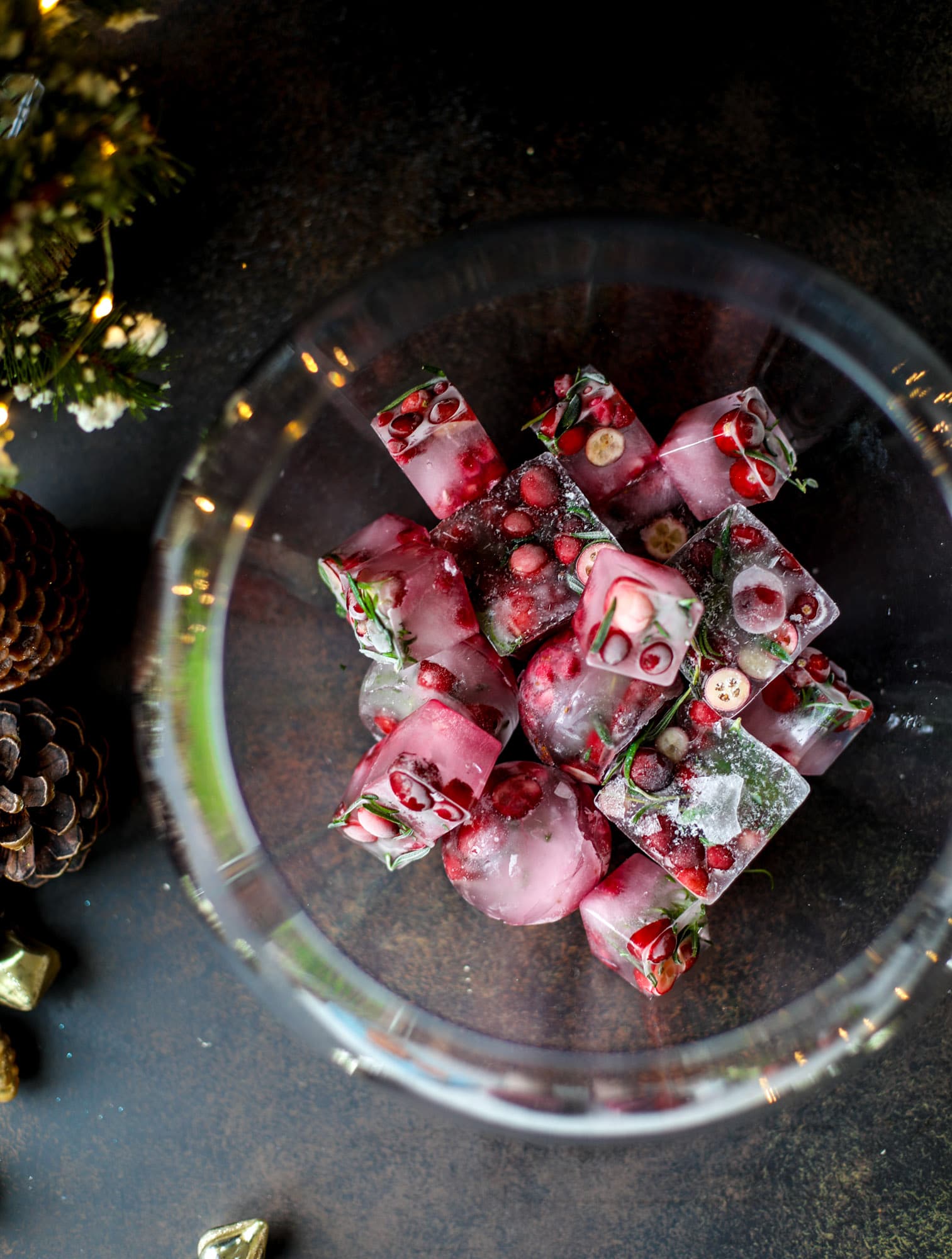This tree trimming punch is the most perfect christmas punch to drink while decorating the tree! Rich red wine is the base and there's a bit of orange, some spice, cinnamon and a gorgeous jeweled holiday ice cubes! I howsweeteats.com #christmas #punch