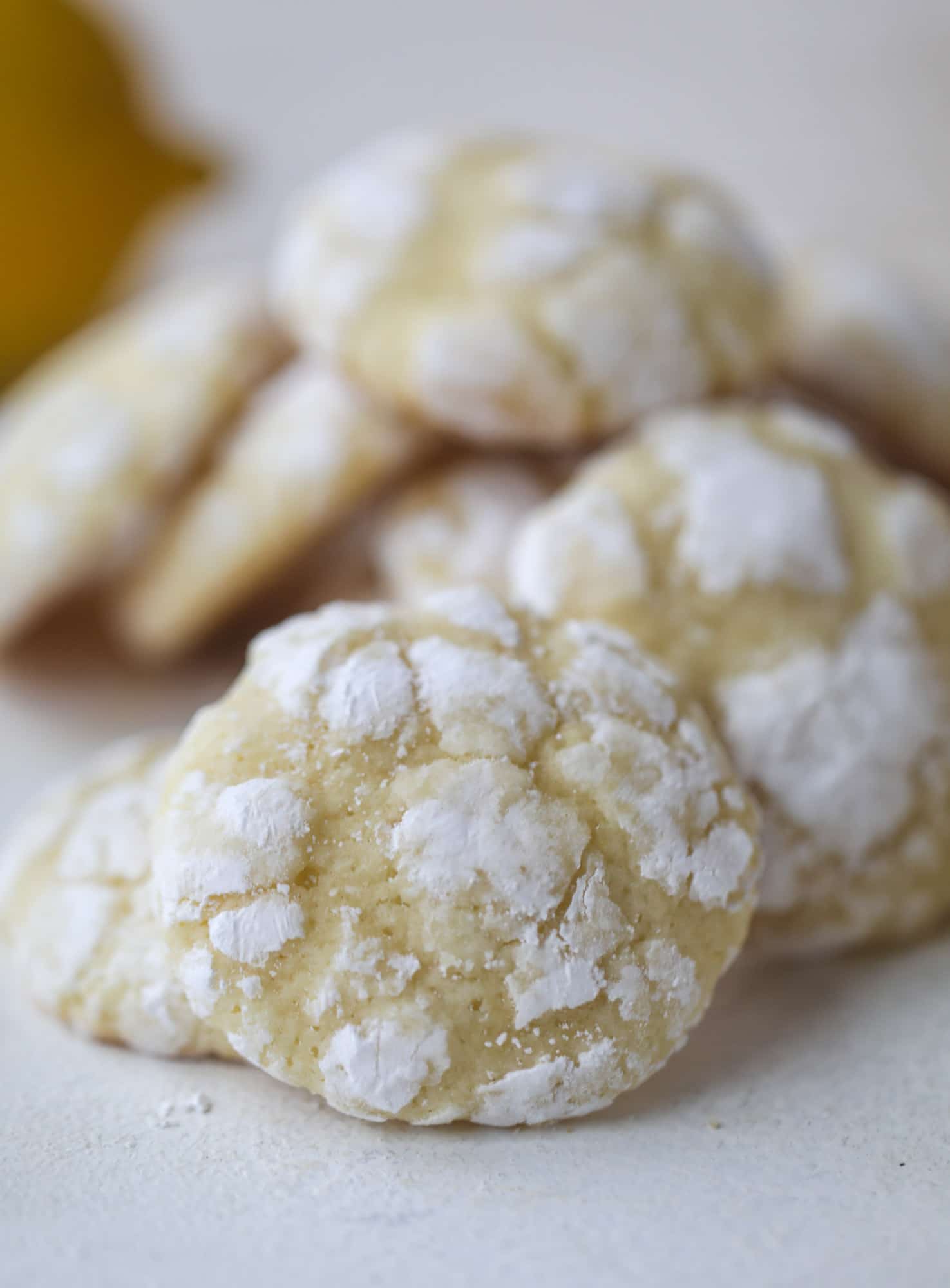 These lemon crinkle cookies are perfect if you love lemon desserts! They take after chocolate crinkle cookies, but are a delightful refreshing lemon flavor sprinkle with powdered sugar. These are always a huge hit! I howsweeteats.com #lemoncrinkle #cookies