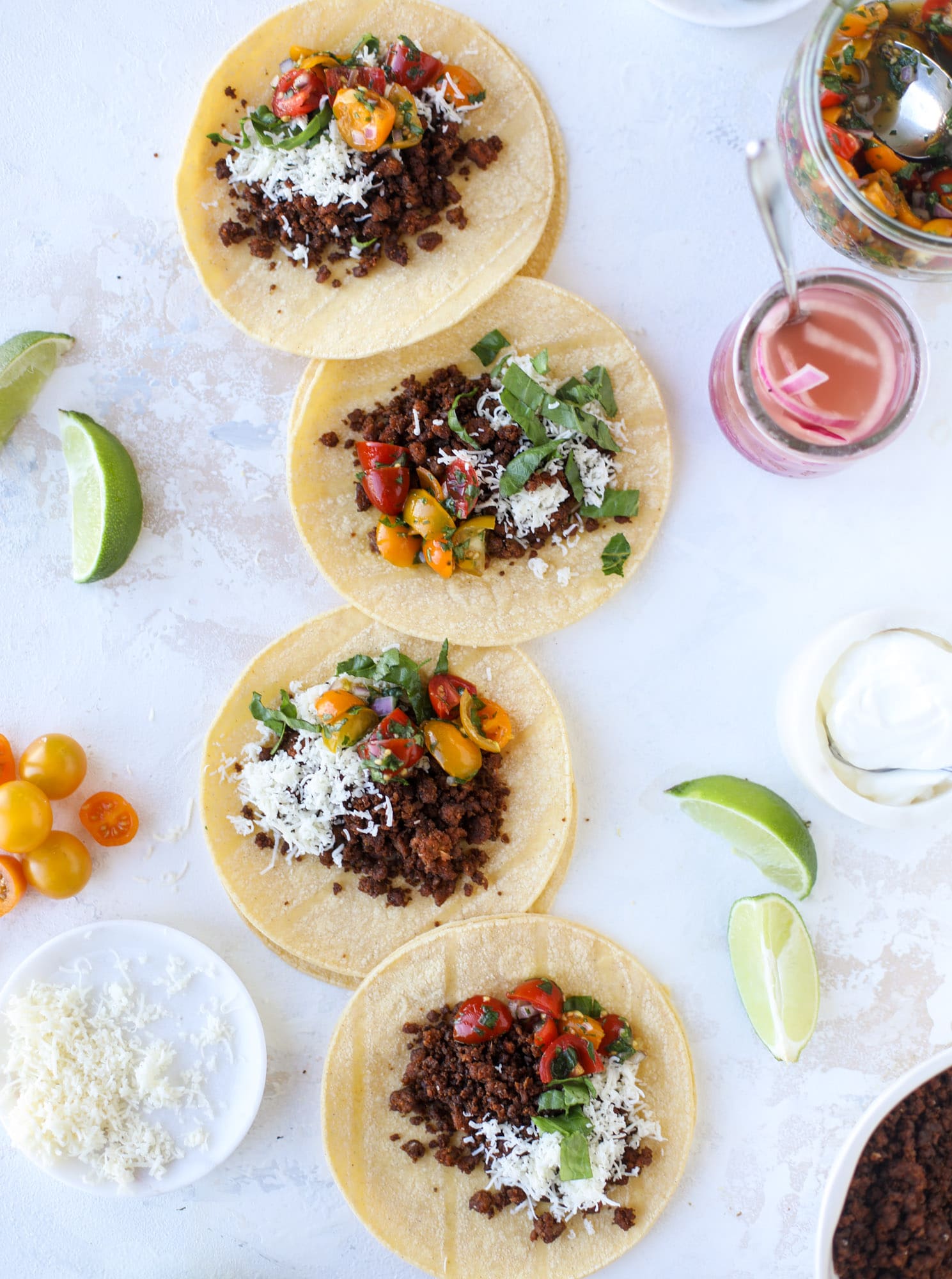 Weeknight ground beef tacos that are anything like the 90s! These are made with a homemade taco seasoning and served with the perfect toppings! I howsweeteats.com #groundbeef #tacos