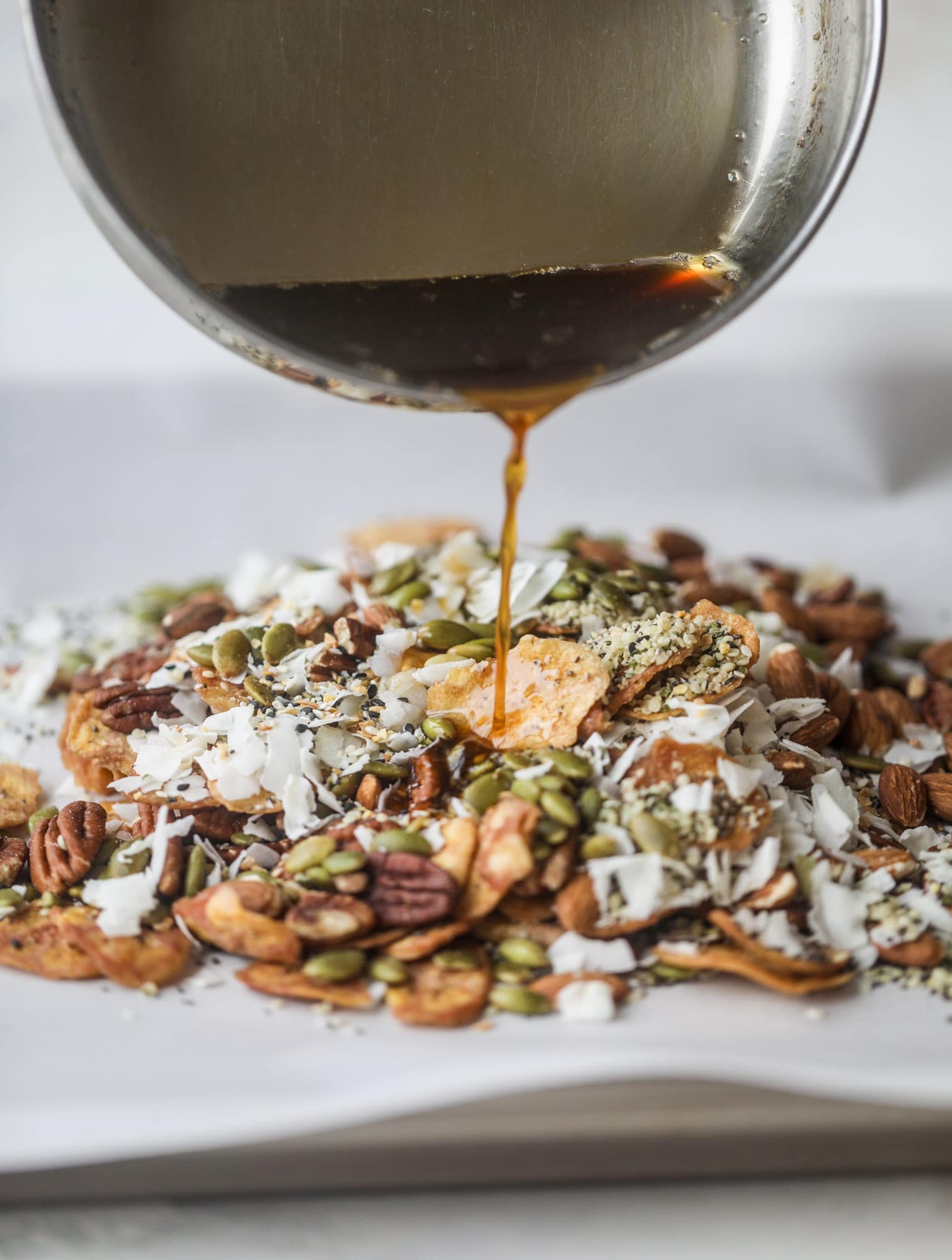 This delicious healthy snack mix is perfect to prep for snacks on the go! It's satisfying, flavorful, both sweet and savory and the best part - is super crunchy. It's full of nuts, some fruit, a bit of coconut, spices, hemp hearts and chia! I howsweeteats.com #healthy #trailmix