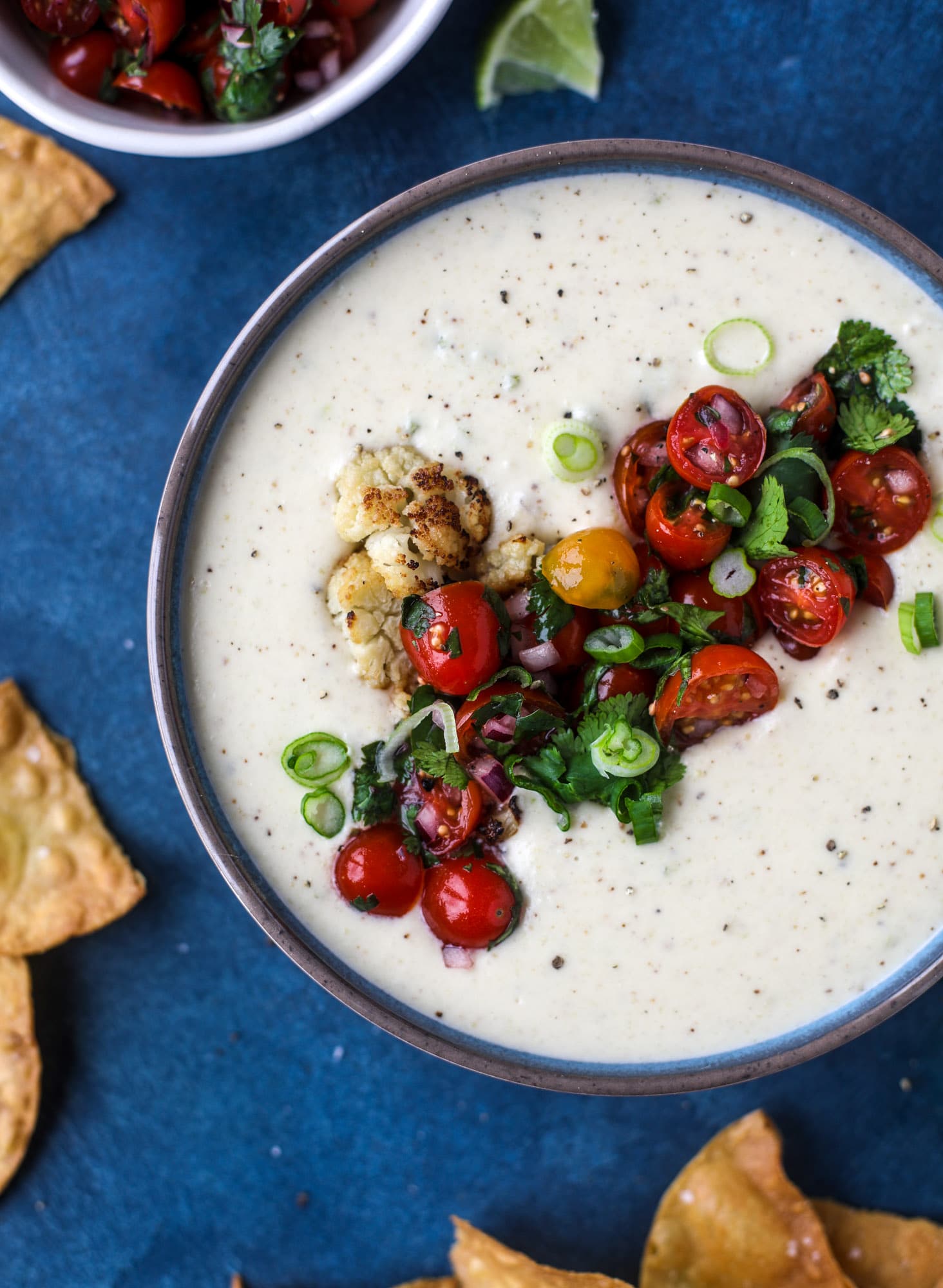 This roasted cauliflower queso has all the deliciousness of regular queso, with roasted cauliflower added in. It's satisfying and tastes like heaven. I howsweeteats.com #cauliflower #queso