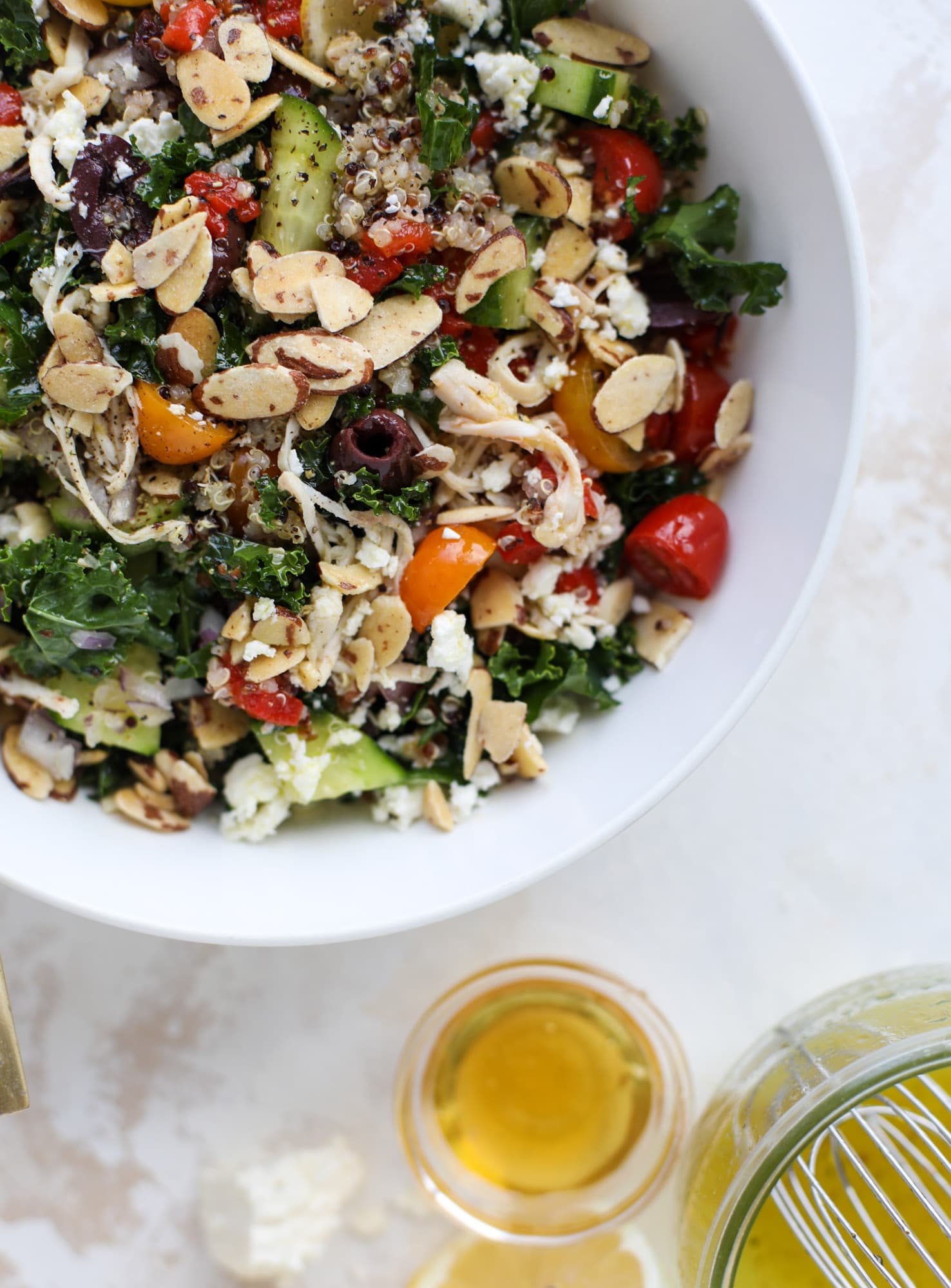 This mediterranean kale and quinoa salad is a copycat for the delicious Panera Bread Modern Greek Salad with Chicken. Super easy and satisfying! I howsweeteats.com #mediterranean #kalesalad