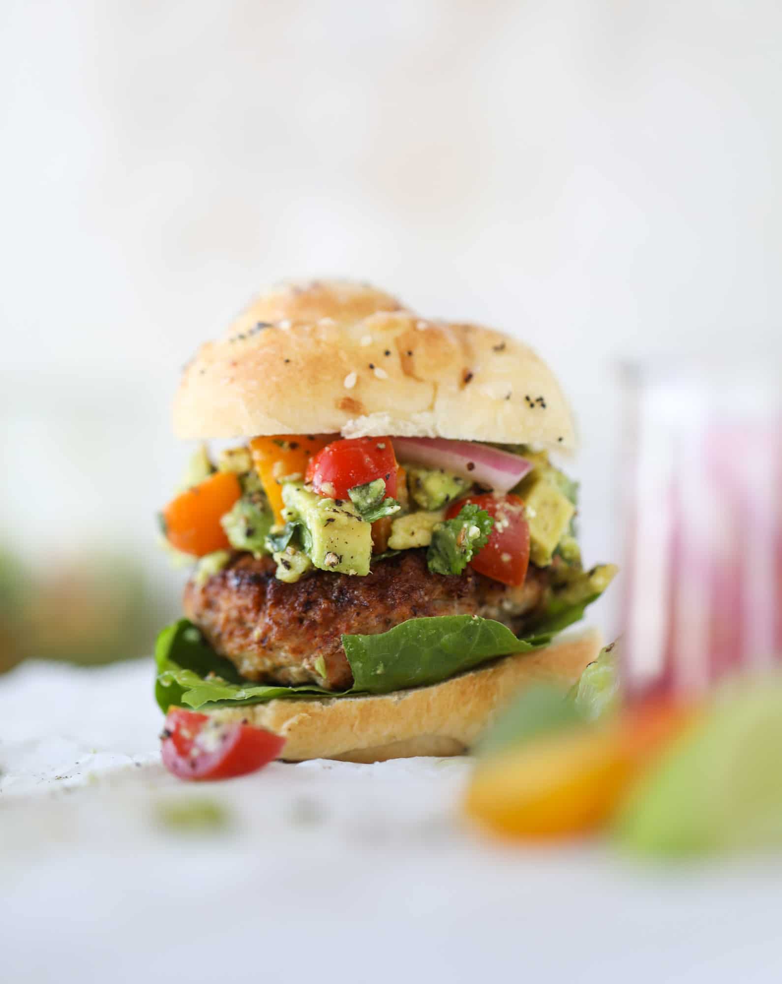 These turkey burgers are full of flavor and topped with a delicious chunky guacamole to take the flavor over the top. The perfect easy dinner! I howsweeteats.com #turkey #burgers