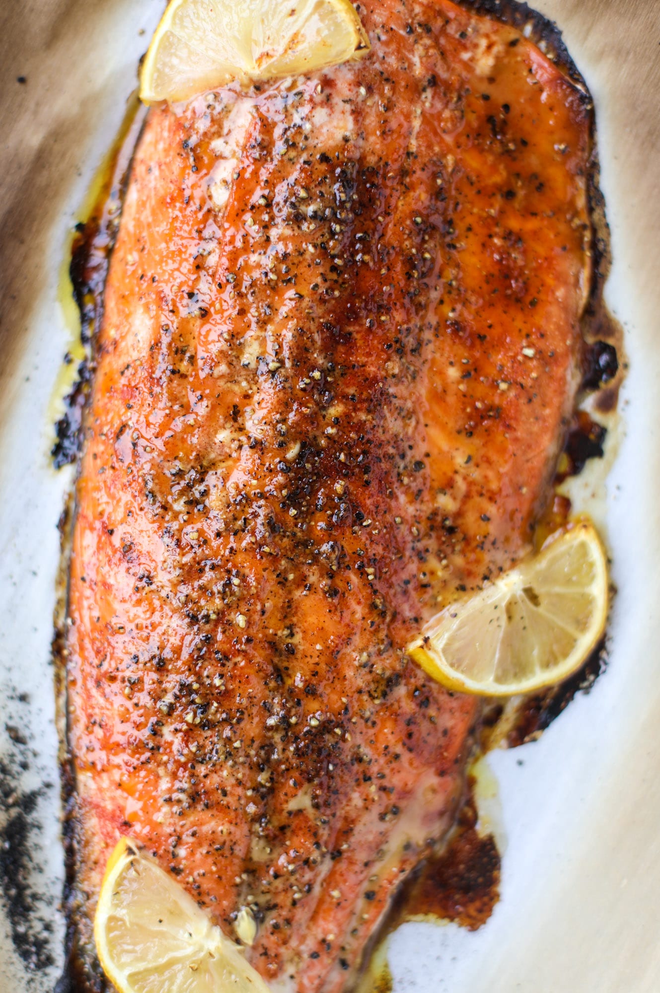 This hot honey salmon is flakey and buttery with a hint of heat and a sprtiz of lemon. It's an easy weeknight meal and is delicious on salads for lunch! I howsweeteats.com #hothoney #salmon