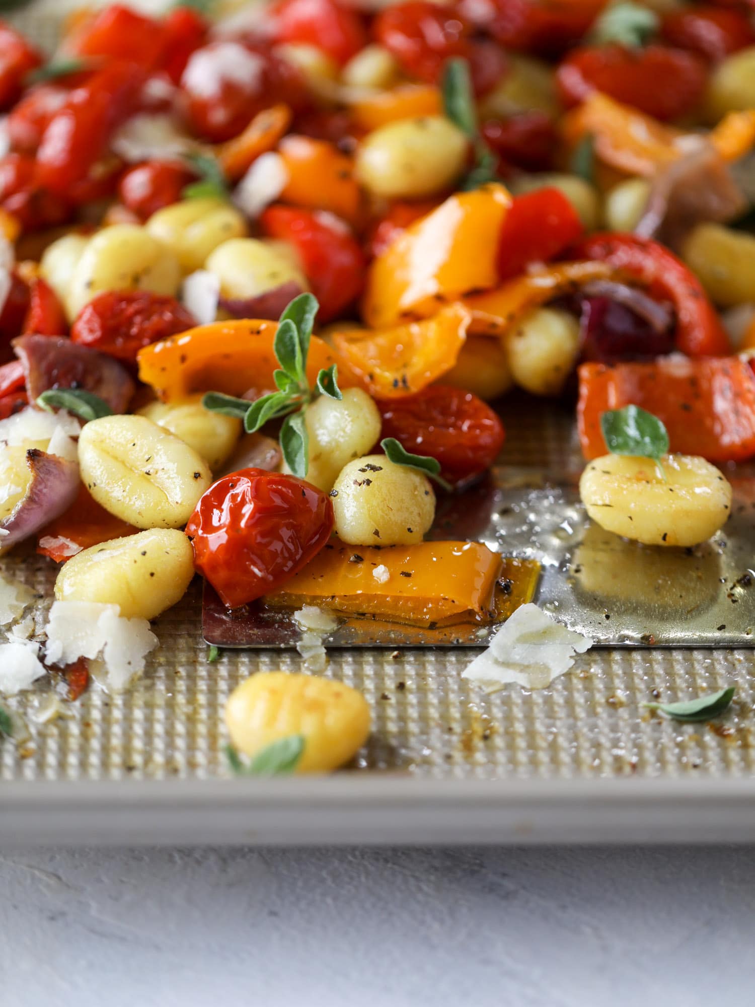 Sheet pan gnocchi is an easy meal that the whole family will love! Toasted gnocchi along with burst tomatoes and caramelized peppers makes the best dinner. I howsweeteats.com #sheetpan #gnocchi