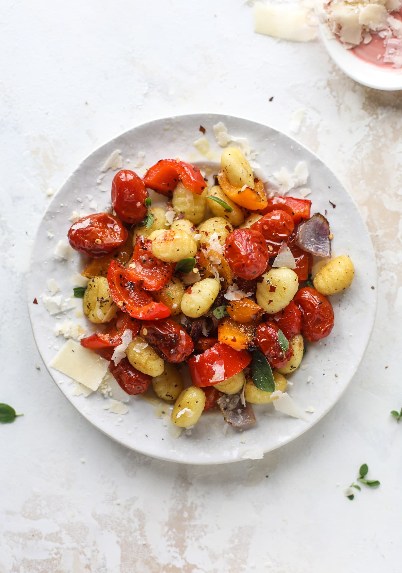 Sheet pan gnocchi is an easy meal that the whole family will love! Toasted gnocchi along with burst tomatoes and caramelized peppers makes the best dinner. I howsweeteats.com #sheetpan #gnocchi
