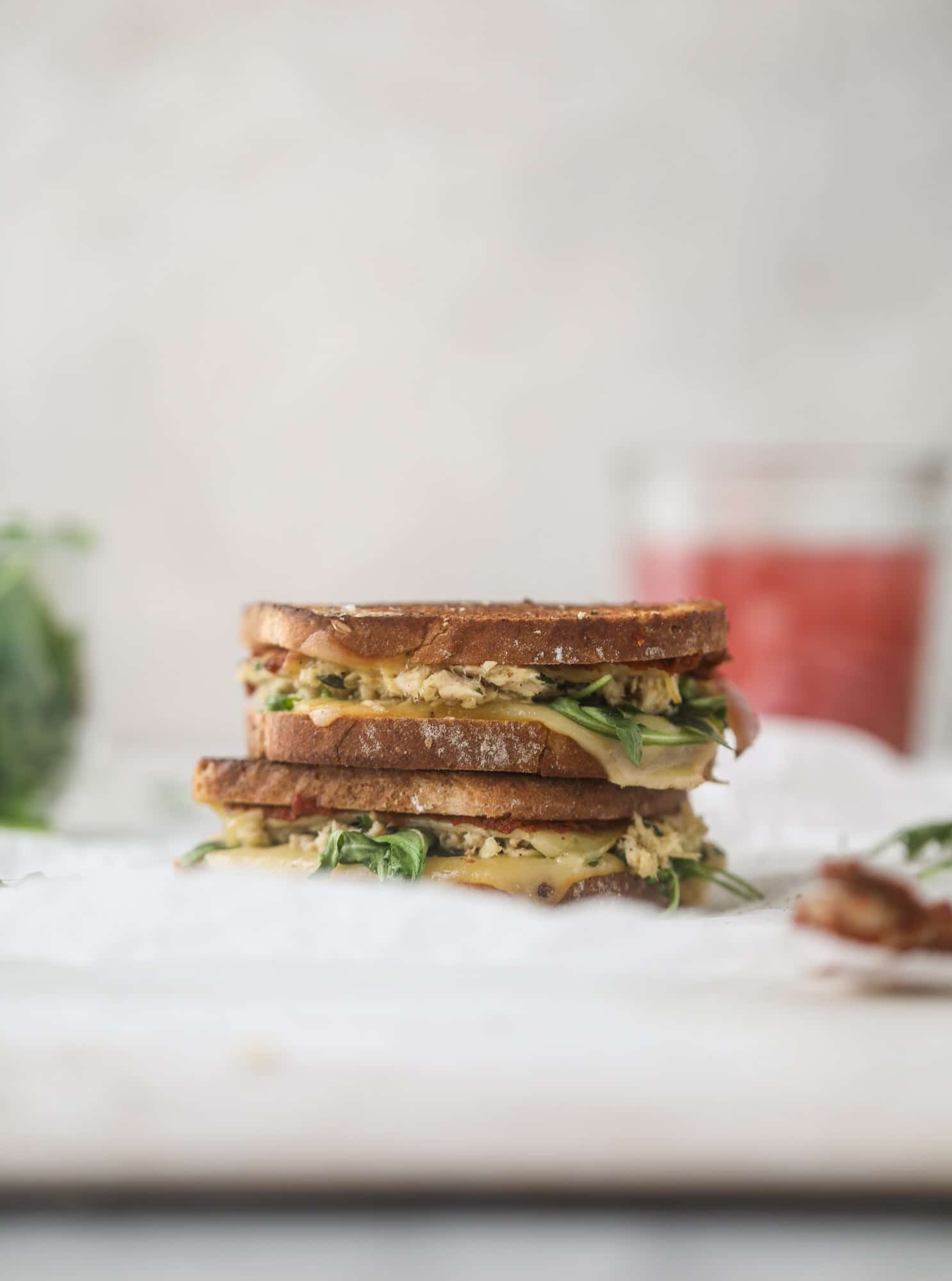 This tuscan tuna melt is a modern way to enjoy a tuna sandwich, with peppery arugula, melty cheese, pickled onions and sun dried tomato spread! I howsweeteats.com #tuna #melt