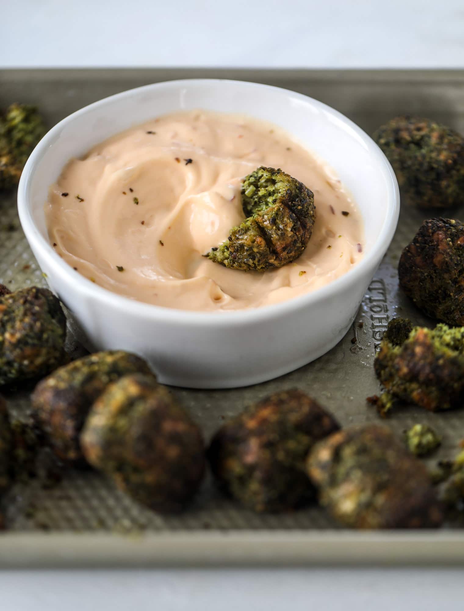 These broccoli cheddar tots are baked, crispy bites of broccoli and sharp cheddar cheese! So delicious and easy to throw together too. I howsweeteats.com #broccolicheddar #tots