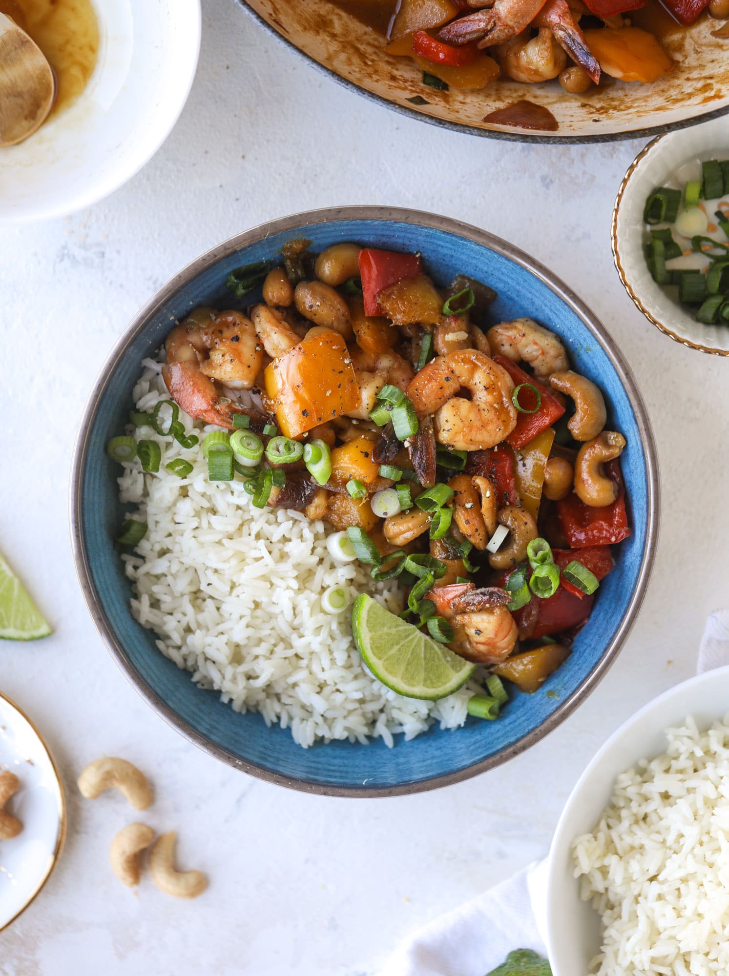 This cashew shrimp stir fry is a super simple weeknight meal! Made with bell peppers and mango, it is delicious over rice and comes together in 25 minutes. I howsweeteats.com #cashew #shrimp